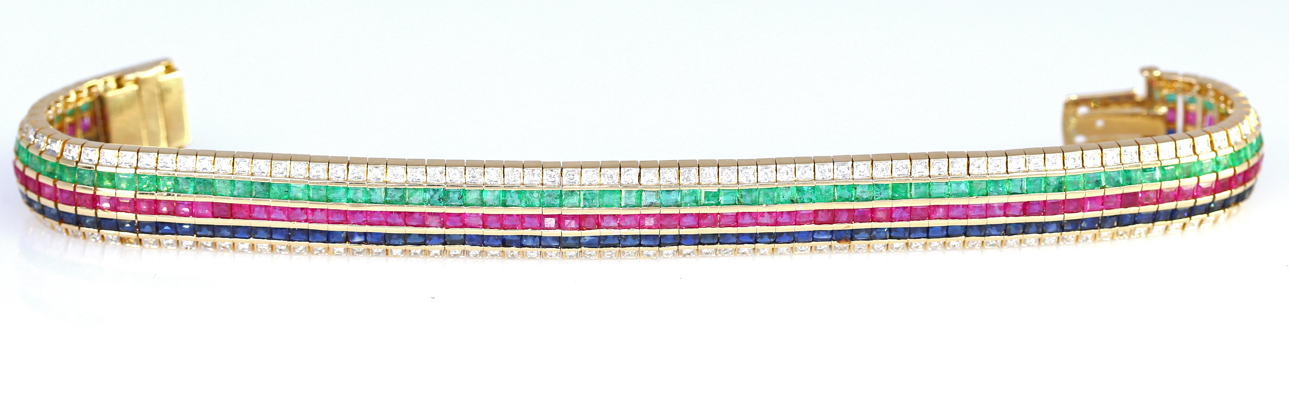 Very flexible, superbly crafted to sit perfectly on a hand. An 18K Yellow Gold Diamond, Ruby, Sapphire and Emerald Bracelet, containing 174 round brilliant cut diamonds weighing approximately 1.74 Ct total, 

87 square step cut rubies measuring