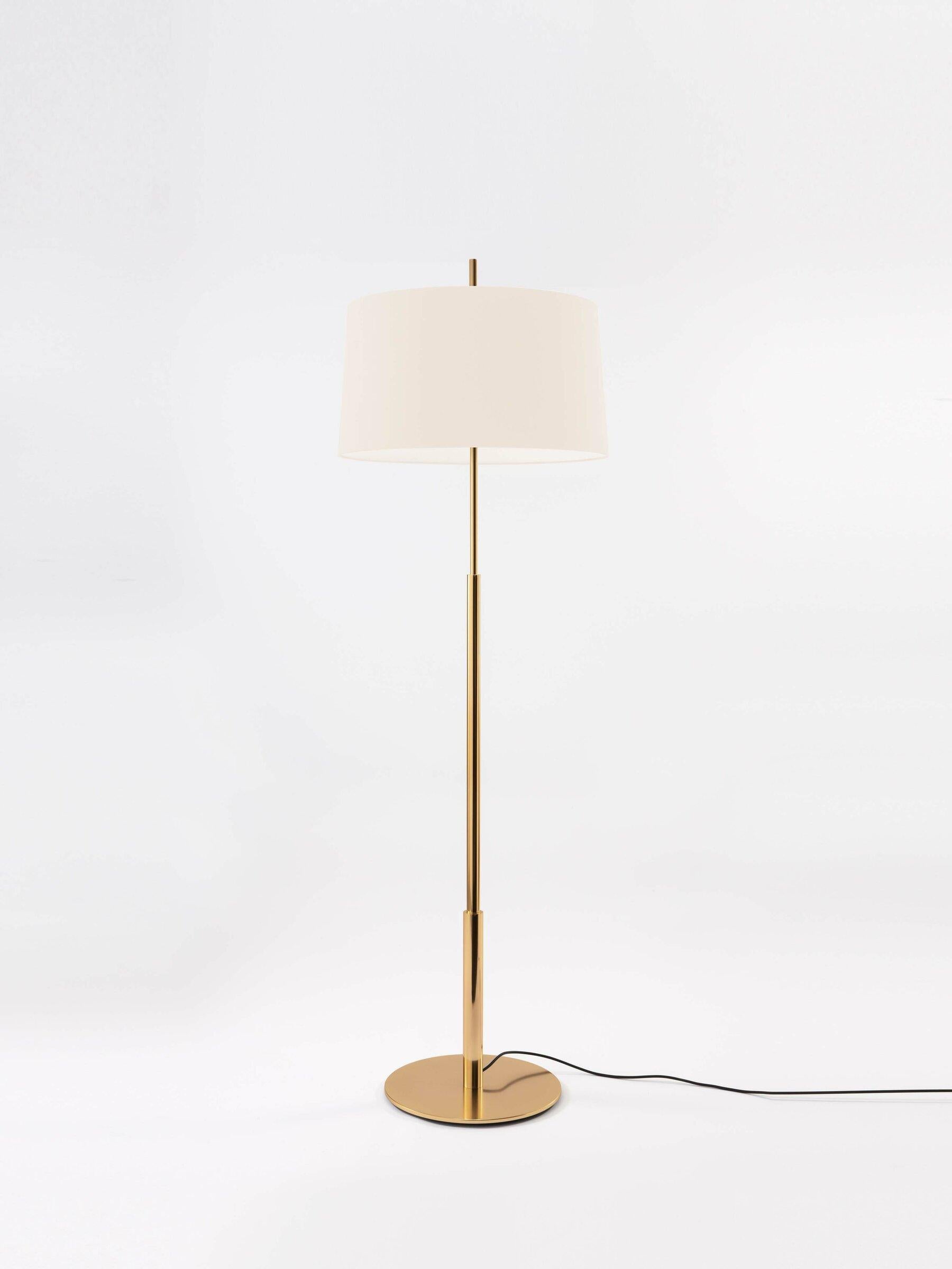 Gold Diana floor lamp by Federico Correa, Alfonso Milá, Miguel Milá
Dimensions: D 45 x H 146 cm
Materials: Metal, linen.
Available in nickel or gold and in black or white shade.

In keeping with the calling of its creators, the Diana lamp has a