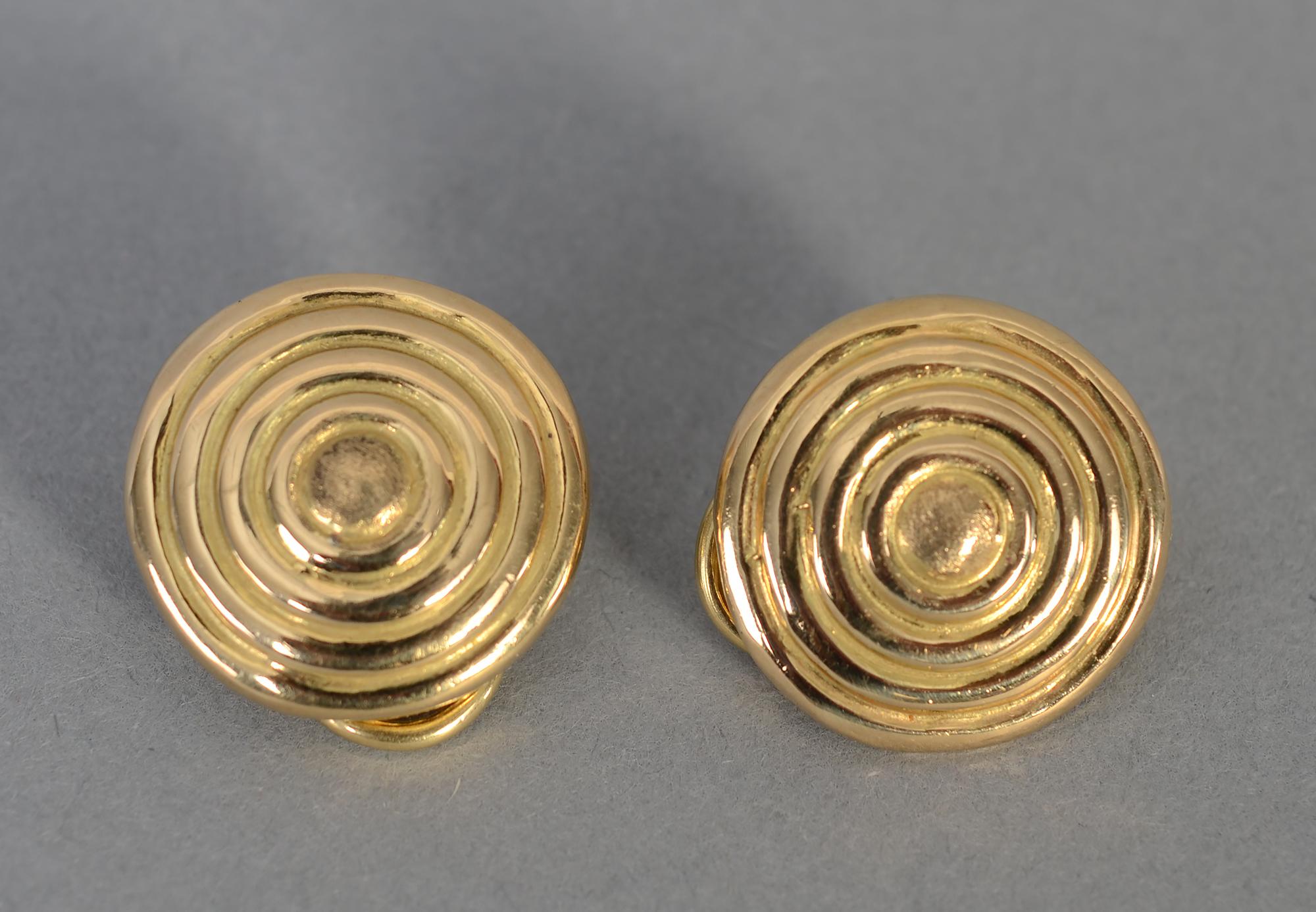 Ideal everyday earrings of 18 karat gold with concentric raised circles. The earrings are 3/4 inch in diameter. Clip backs can be converted to posts.