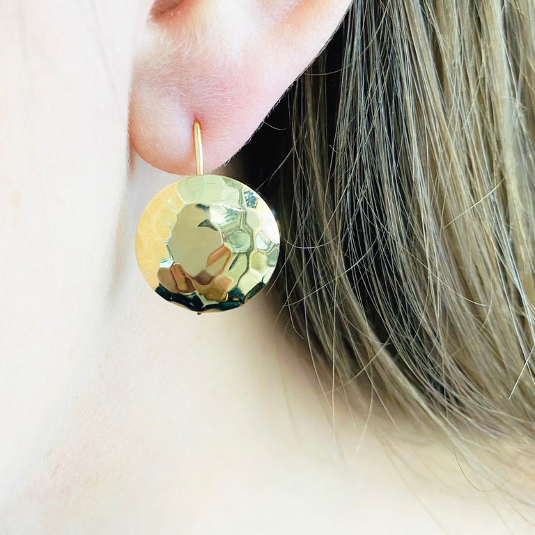 These stunning hammered 14k yellow gold earring disks provide a look that is both trendy and classic. These earrings are a great staple to add to your collection, and can be worn with both casual and formal wear. These earrings would make the