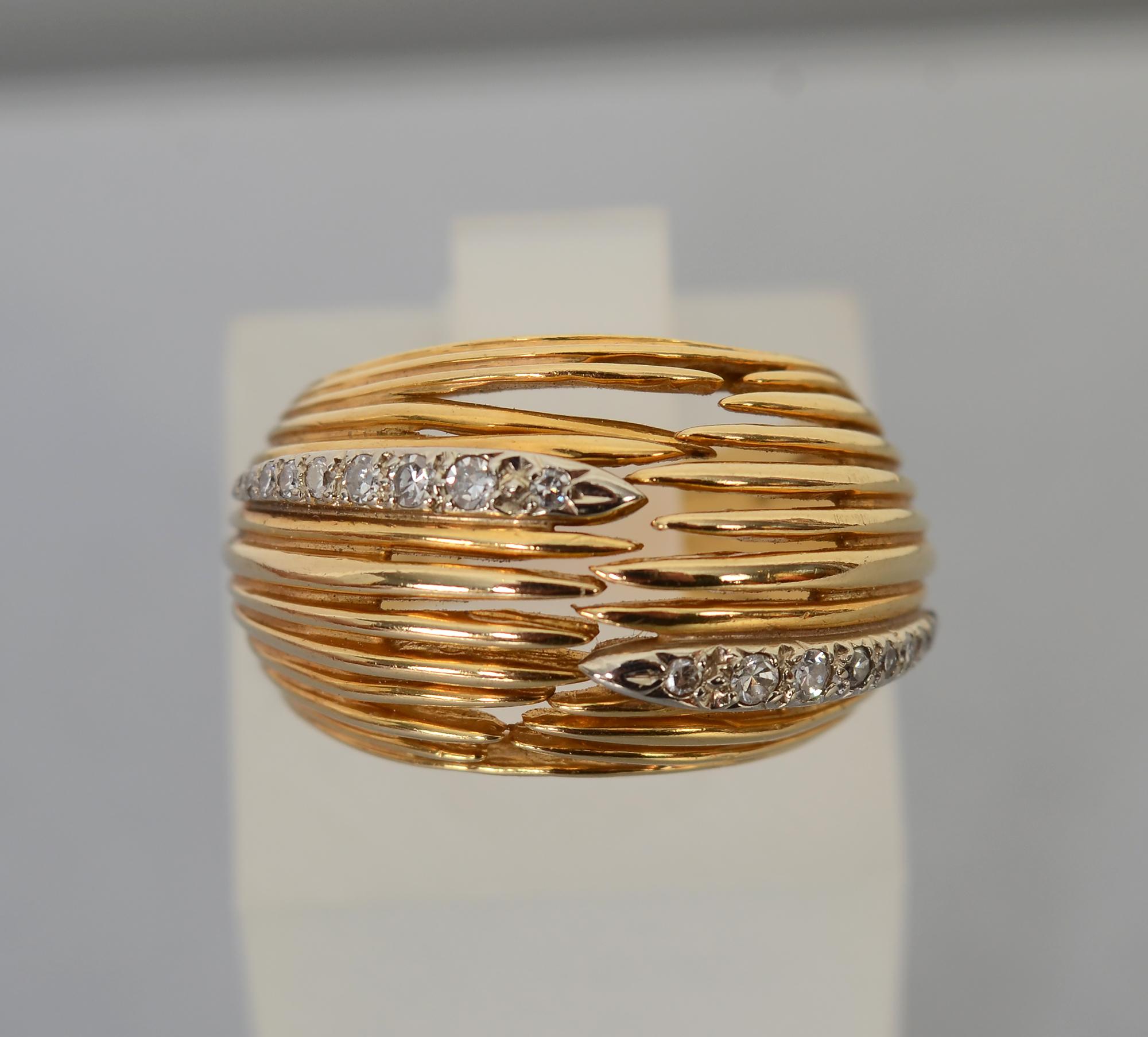 Gold dome ring made of 18 bands of 14 karat gold. The bands have spaces between them at different places creating a nice, irregular openwork design. Eighteen graduated size diamonds are arranged in two rows. The ring measures 9/16