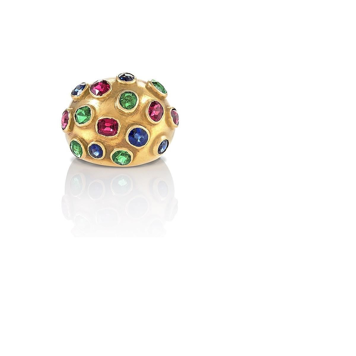 A French 18 karat gold domed ring with sapphires, rubies and emeralds. Each stone is set in a bezel around the top portion of the ring.  Circa 1950's.

Dimensions: Size 6. This ring can be sized.