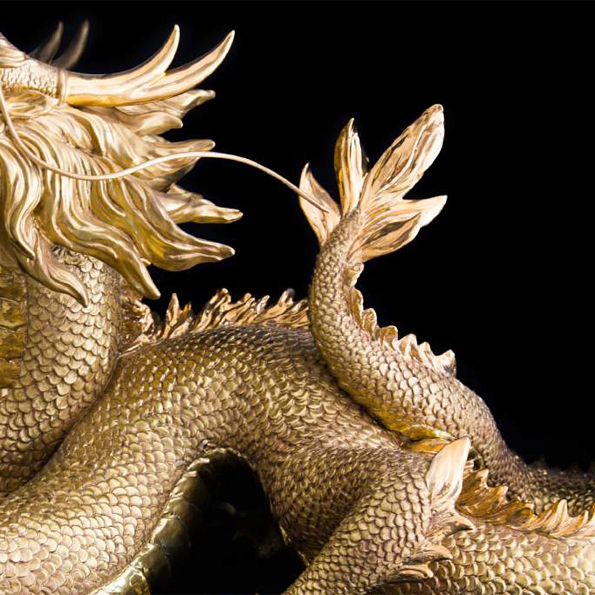metal reading dragon sculpture
