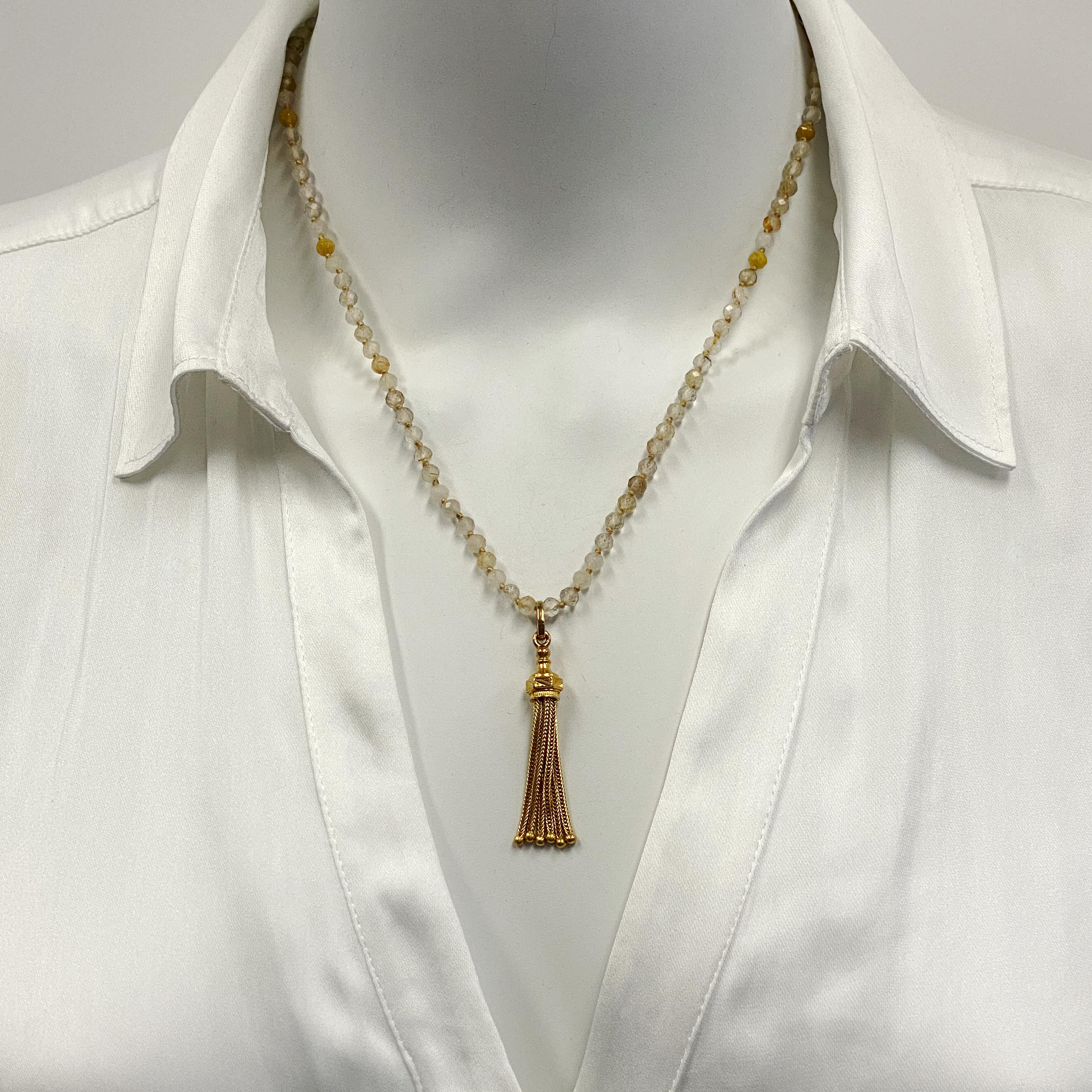 This versatile piece features an old 10 karat gold tassel which Eytan Brandes converted to a pendant with a big top loop -- big enough to accommodate many different chain options.

We've paired it with a string of fully knotted, natural pale yellow