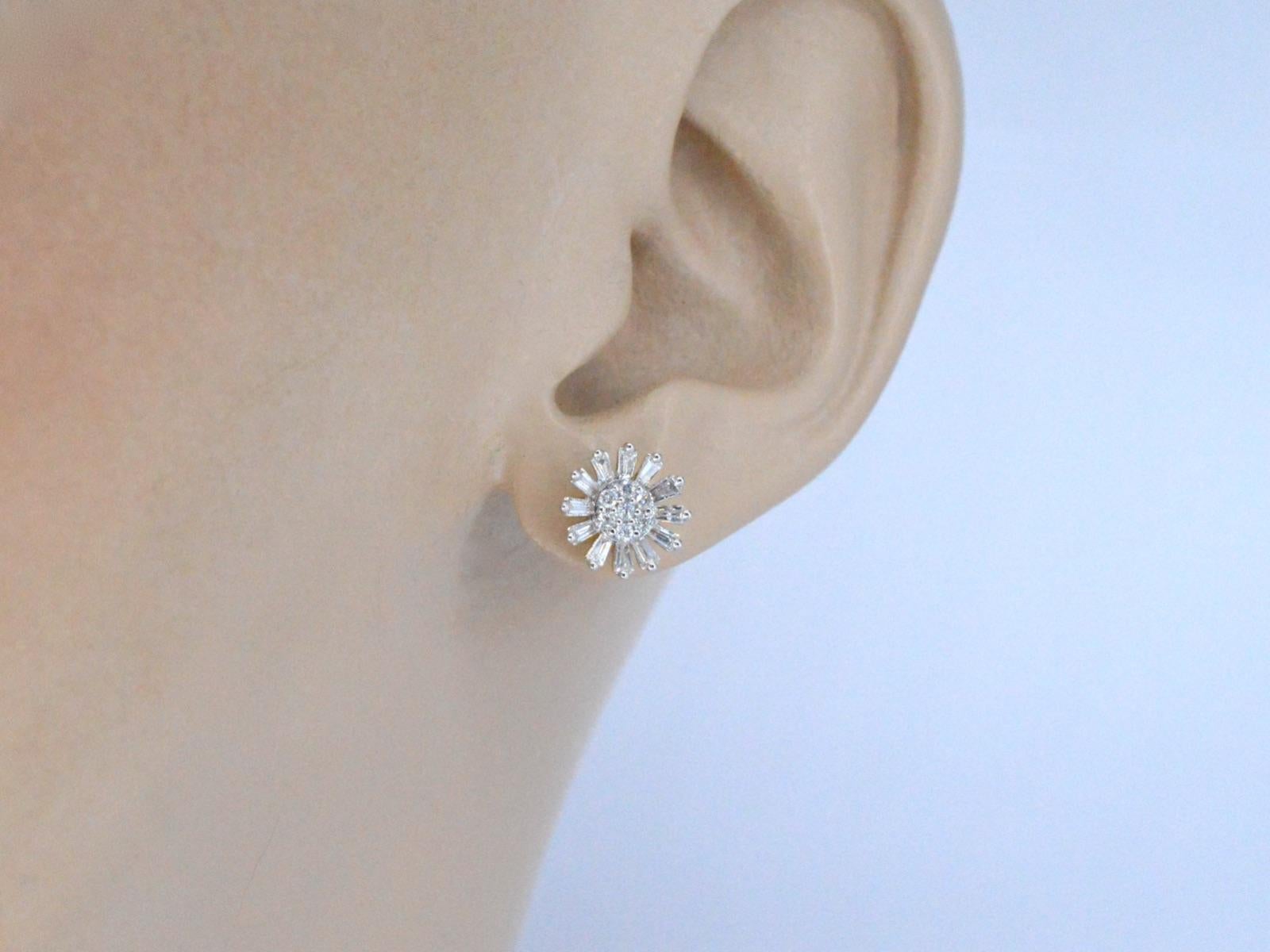 These 14K gold earrings are a beautiful and delicate piece of jewelry designed in the shape of a flower. The gold is a high-quality metal that is known for its durability and lustrous properties. The earrings feature intricate details, the petals