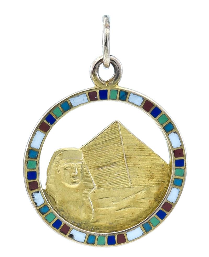 Very interesting and unique charm:  a depiction of a pyramid and a pharaoh,  cut-out in the center of a multi-color enamel border. Pattern and relief are continued on the reverse side.  14K yellow gold.  3/4