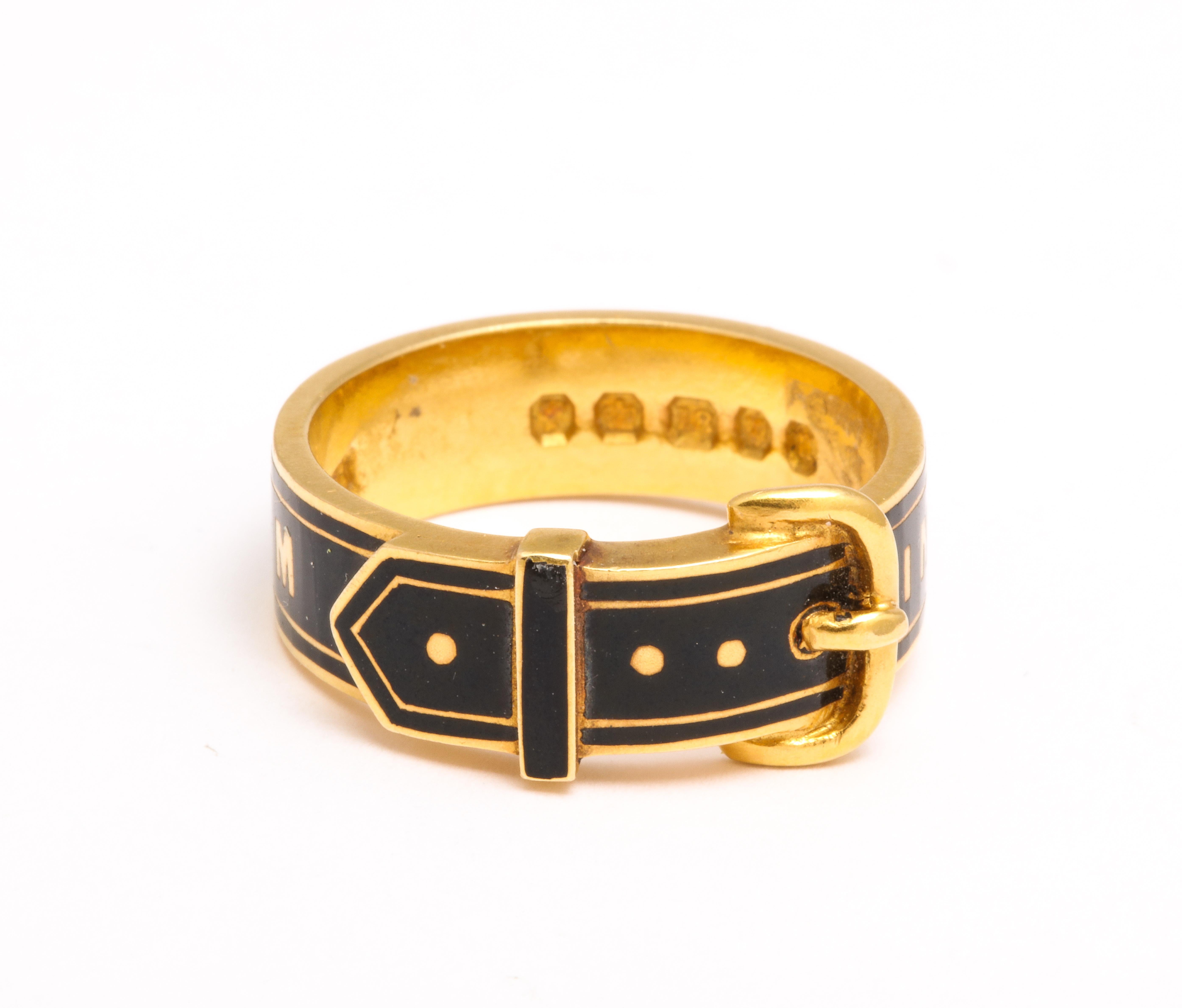 A pristine 18 Kt buckle ring with graphic gold letters that say 