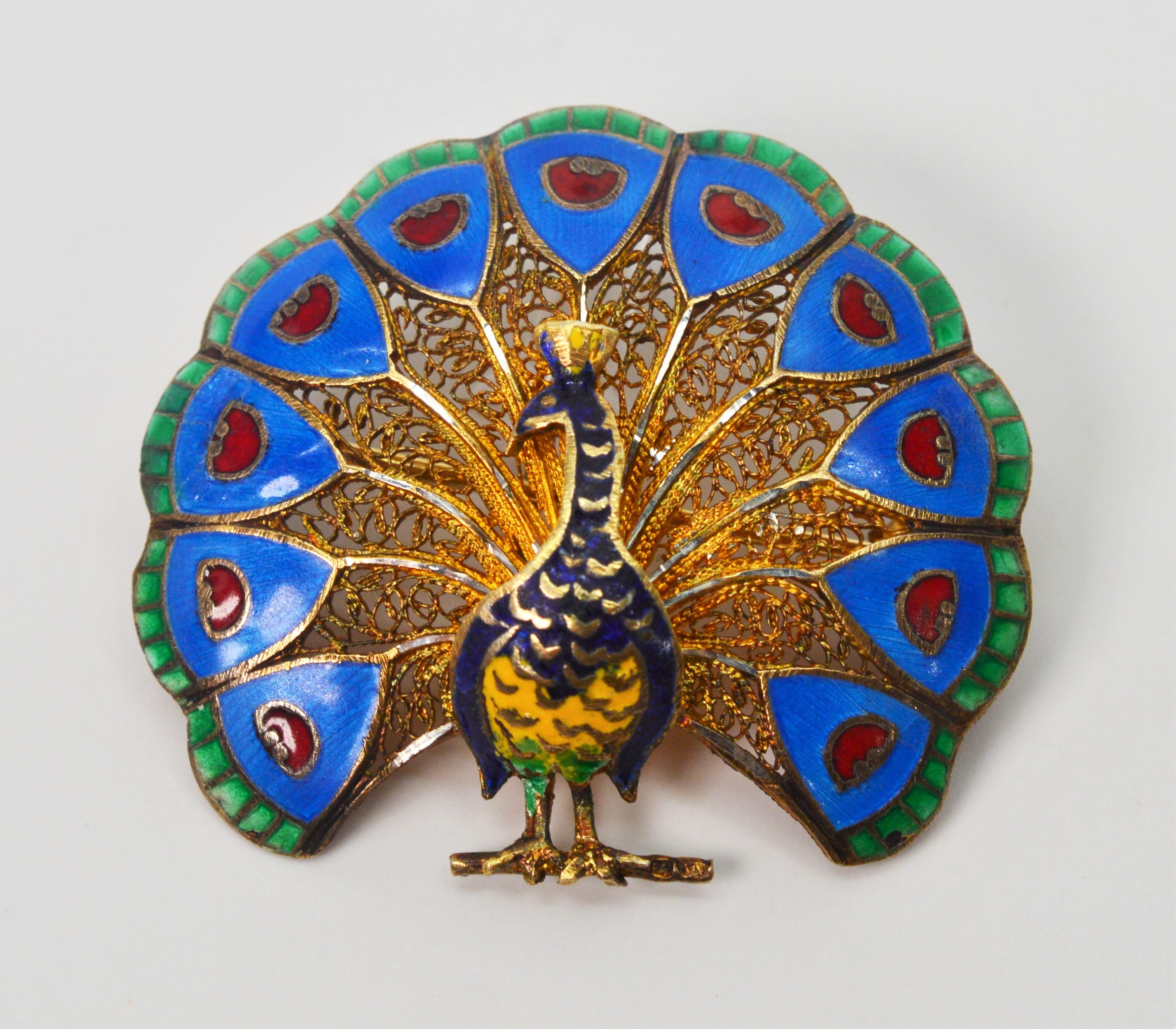 Often the symbol of pride and vanity, this artisan crafted Peacock has colorful plumage crafted with hand applied enamels outlined in gold. Made on the subcontinent of India, the brooch is constructed of ten carat yellow gold with a decorative