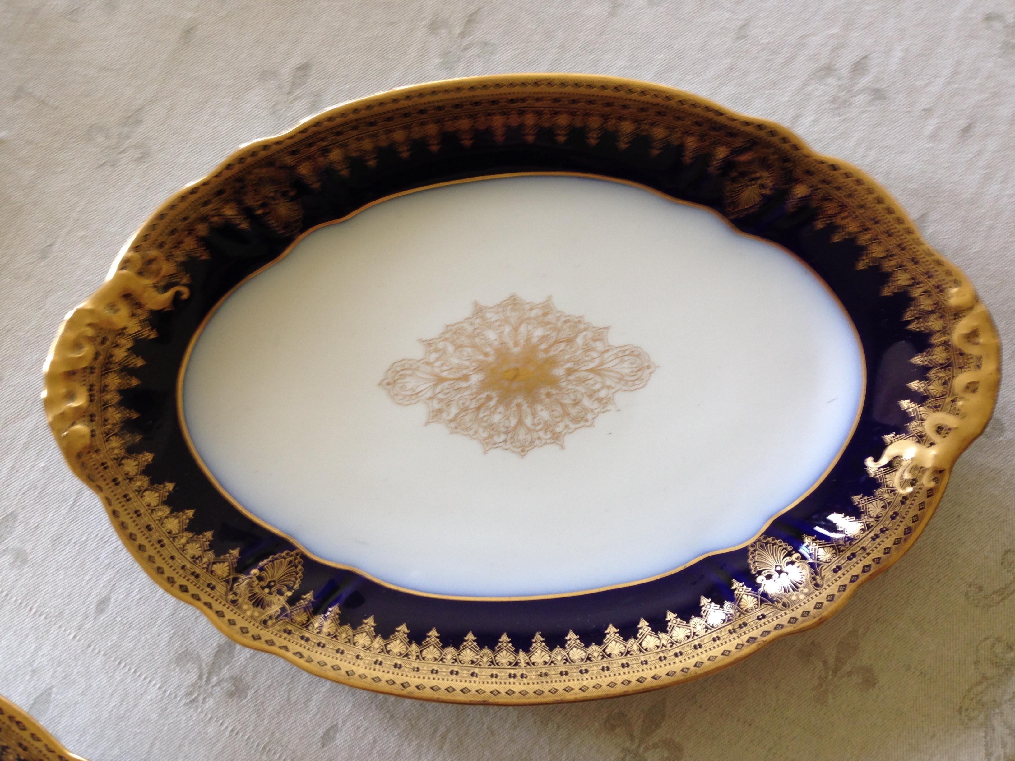 Created by the factory of Wm. Guerin (1838-1912) in Limoges, France, these three nested cobalt on white platters are heavily encrusted with hand applied gold. These platters have rarely been used and glow under evening lighting as the gold is in