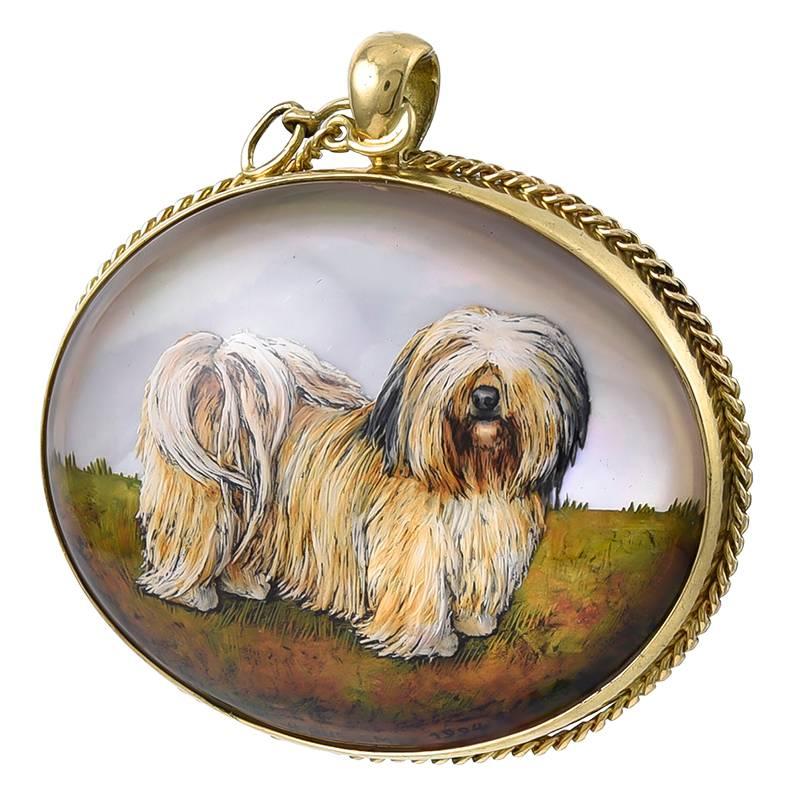 Large 18K yellow gold pendant, with an Essex crystal depicting a dog.   Charming subject, with a fluffy fur coat and fur covering his eyes.  Applied rope border that wraps around to form a leash.  1 1/4