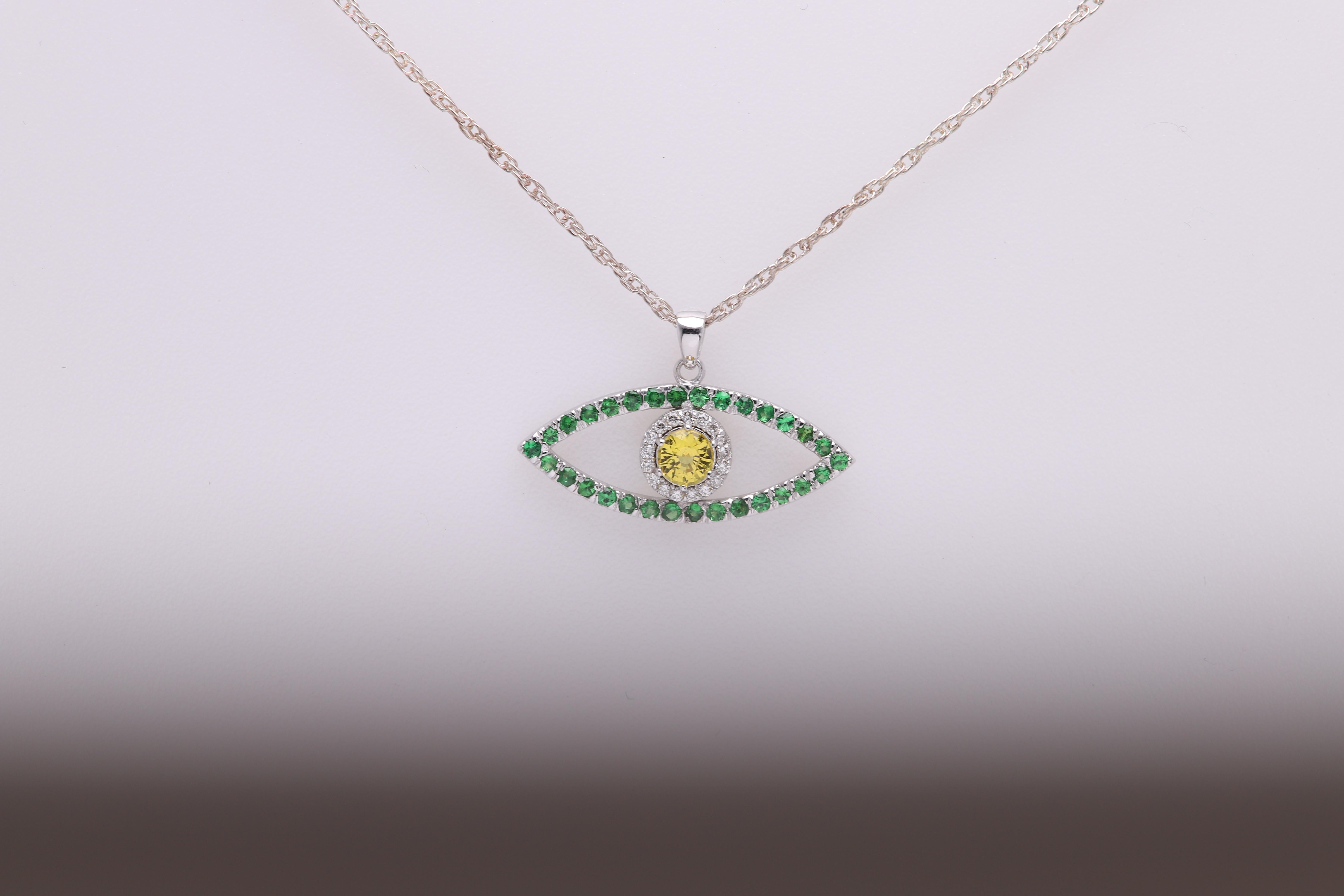 Brillante ciondolo a forma di occhio maligno made in USA 
Oro bianco 14k 1,80 grammi (peso senza catena)
Diamanti piccoli circa 0,10 ct
Tsavorite circa 0,400 carati
Pietra centrale - Zaffiro giallo brillante di circa 0,40 carati
TUTTE LE PIETRE SONO