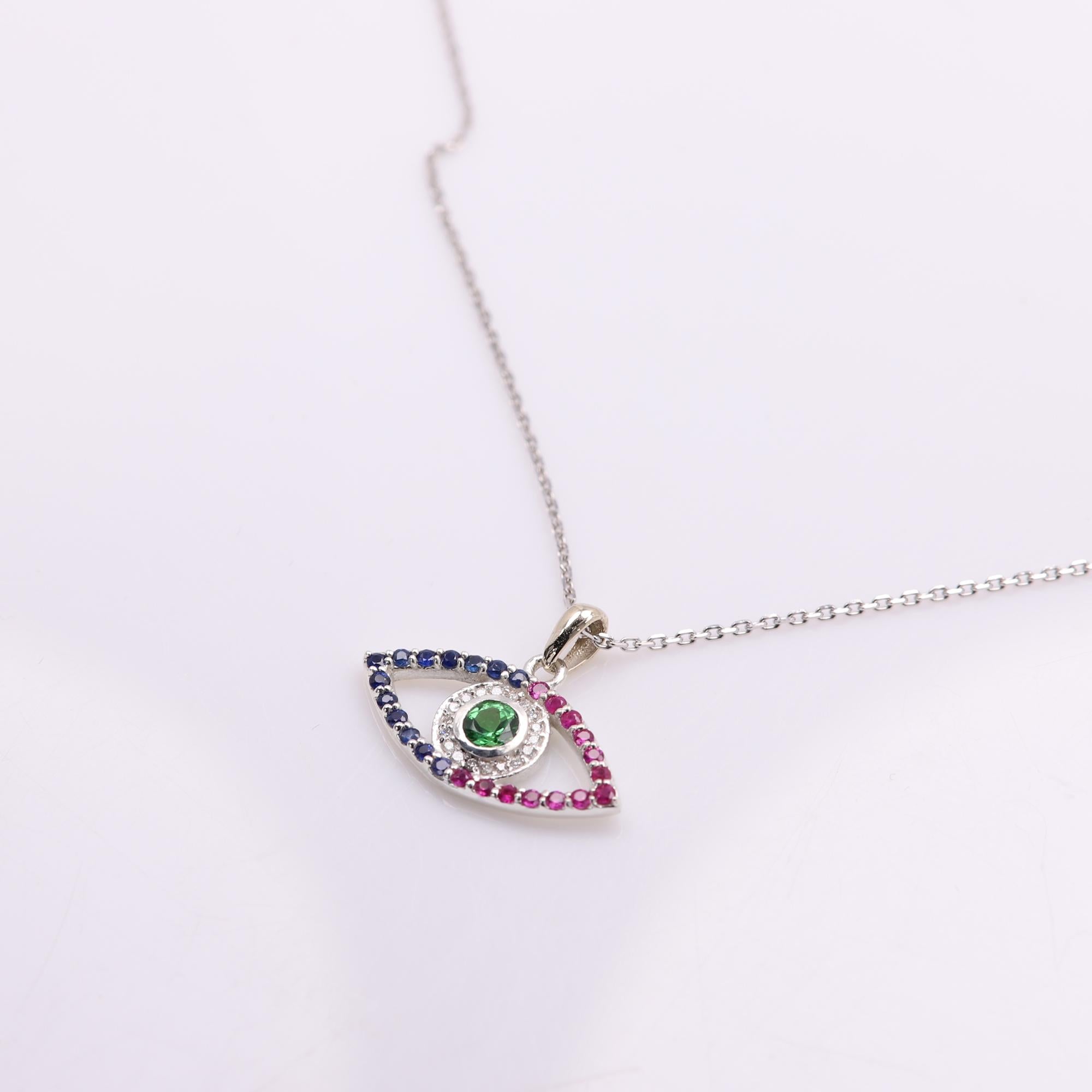 Brilliant Colors of mixed natural Gemstones
made in USA Evil Eye pendant 
14k White Gold 2.0 grams (weight without the chain)
Small Diamonds approx. 0.10 ct
Green Tsavorite center approx. 0.40 carat
Small natural Diamonds approx.0.10 carat G-VS
Reb
