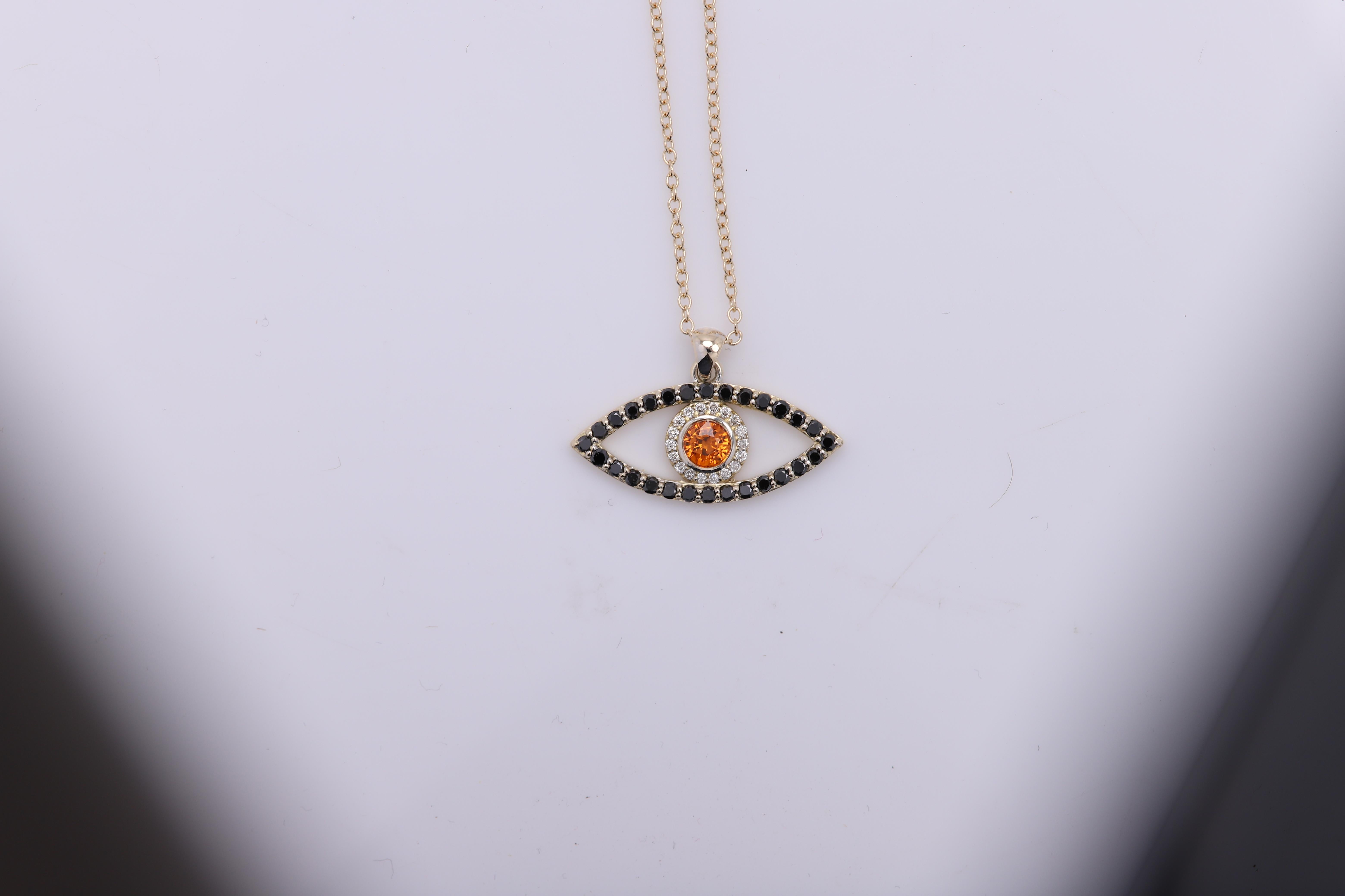 Brilliant made in USA Evil Eye pendant 
14k Yellow Gold 2.40 grams (weight without the chain)
Small Diamonds approx 0.10 ct
Black Diamonds Approx 0.30 ct
Center stone - Brilliant Orange Sapphire approx 0.50 carat
ALL STONES ARE NATURAL !
eye size 1'