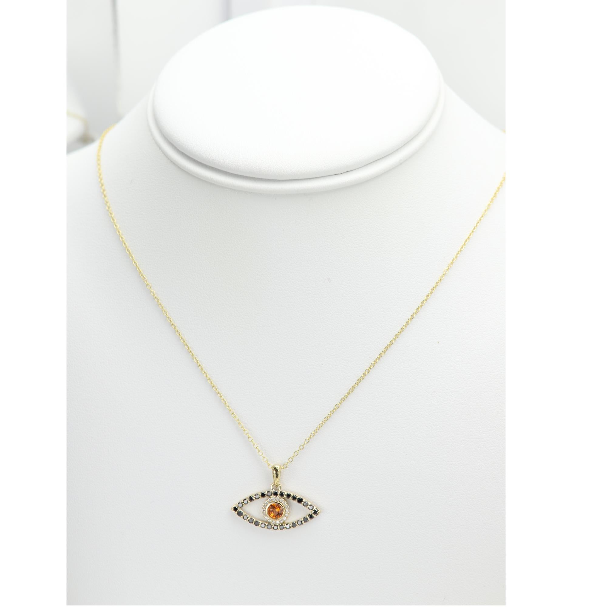 Brilliant made in USA Evil Eye pendant 
Center stone - Brilliant Natural Orange Sapphire approx 0.50 carat AAA
14k Yellow Gold 2.40 grams (this weight is without the chain)
Natural Small Diamonds approx 0.10 ct
Natural Black Diamonds Approx 0.30