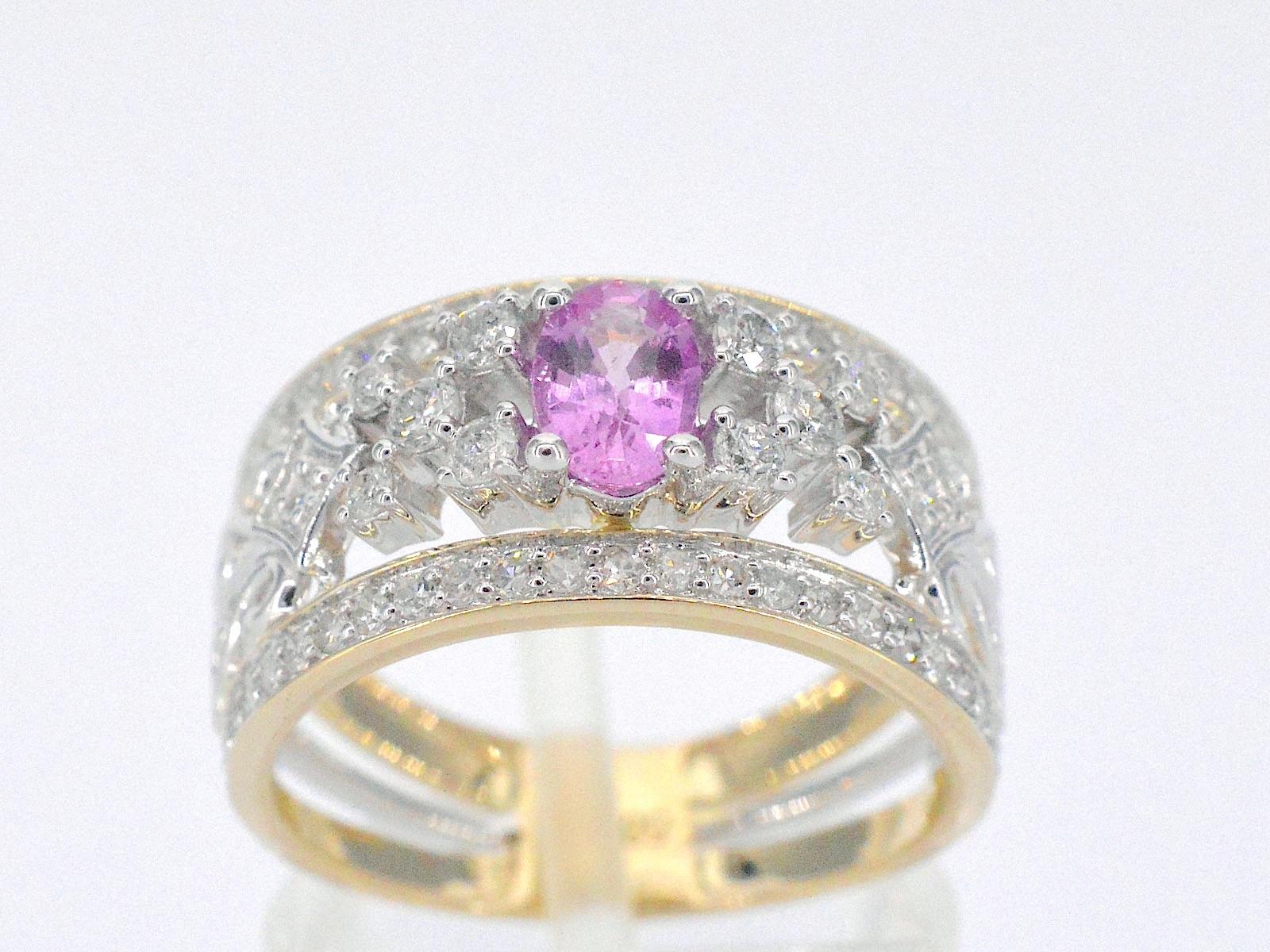 This 14K gold ring is an exclusive and luxurious piece of jewelry, adorned with a stunning pink sapphire and numerous sparkling diamonds. The gold is a high-quality metal that is known for its durability and lustrous properties. The diamonds are