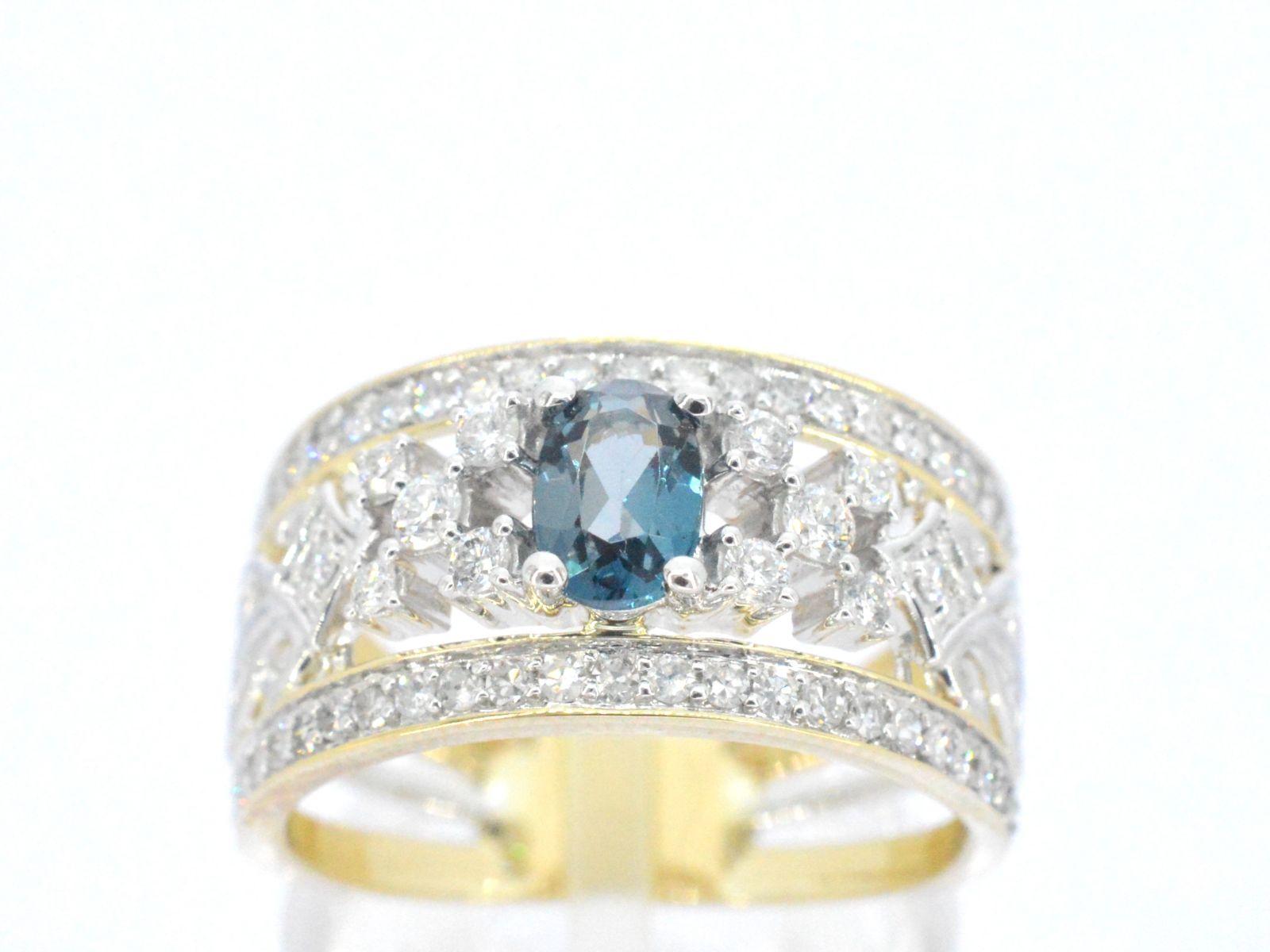 This exclusive gold ring is a dazzling display of luxury and elegance, featuring an array of sparkling diamonds and a brilliant topaz gemstone. The intricate design of the ring highlights the natural beauty of the topaz, while the diamonds add an