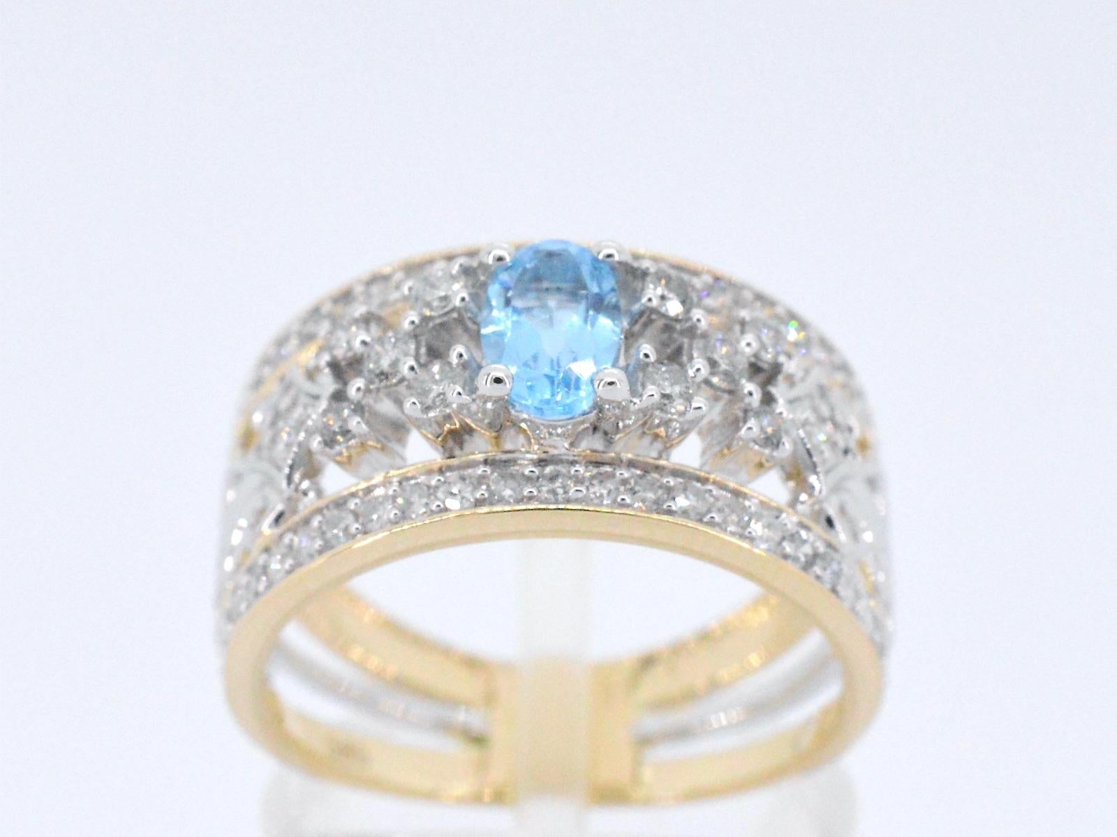 This exclusive gold ring is a beautiful piece of jewelry that features sparkling diamonds and a stunning topaz. The diamonds are expertly set in the gold band to create a seamless and elegant look that catches the light beautifully. The topaz adds a