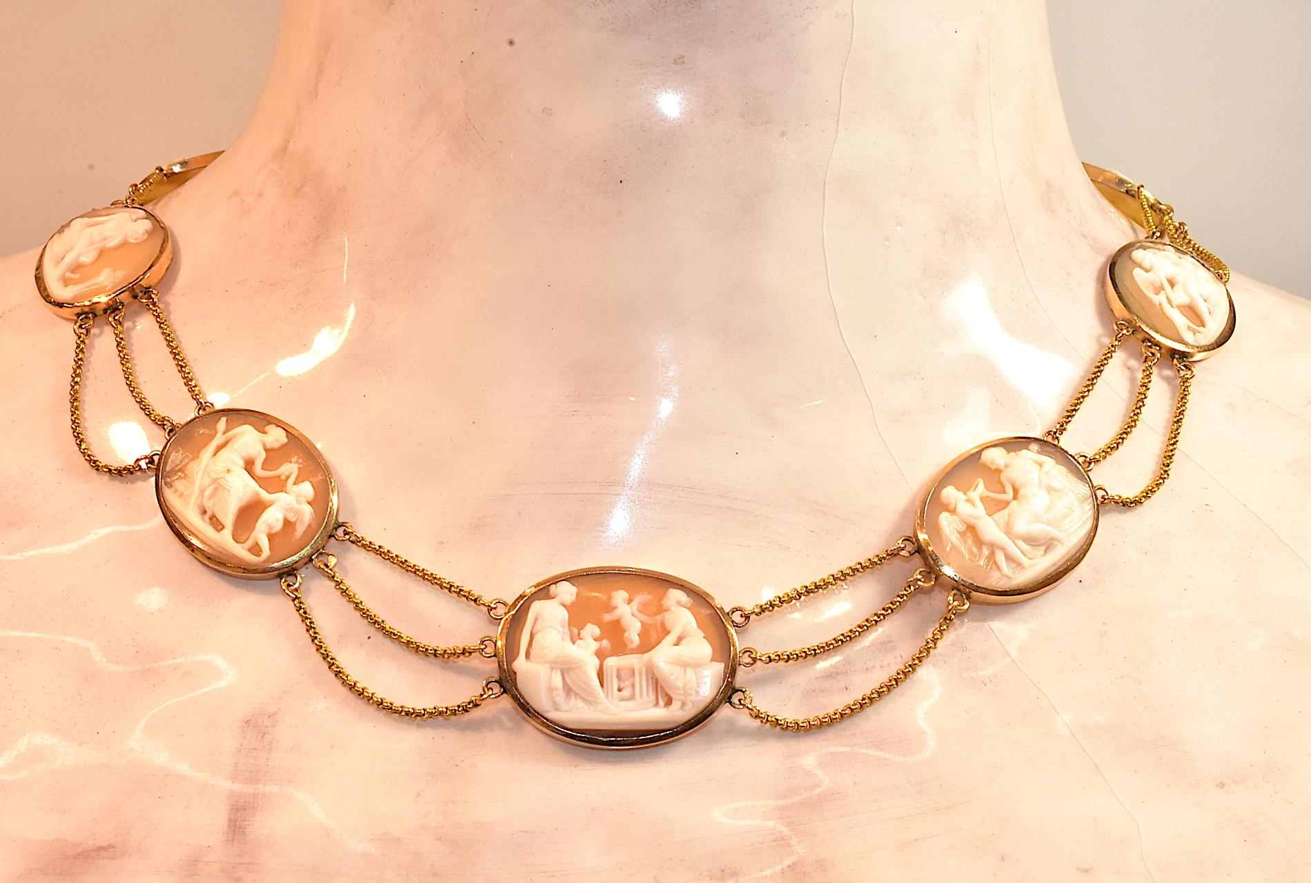 Antique 18K neoclassical carved shell cameo necklace with ten graduated bezel-set cameos each depicting a different mythological scene. Each cameo plaque links to the next with triple swags of 18 carat festoon chain, in the style known as esclavage.