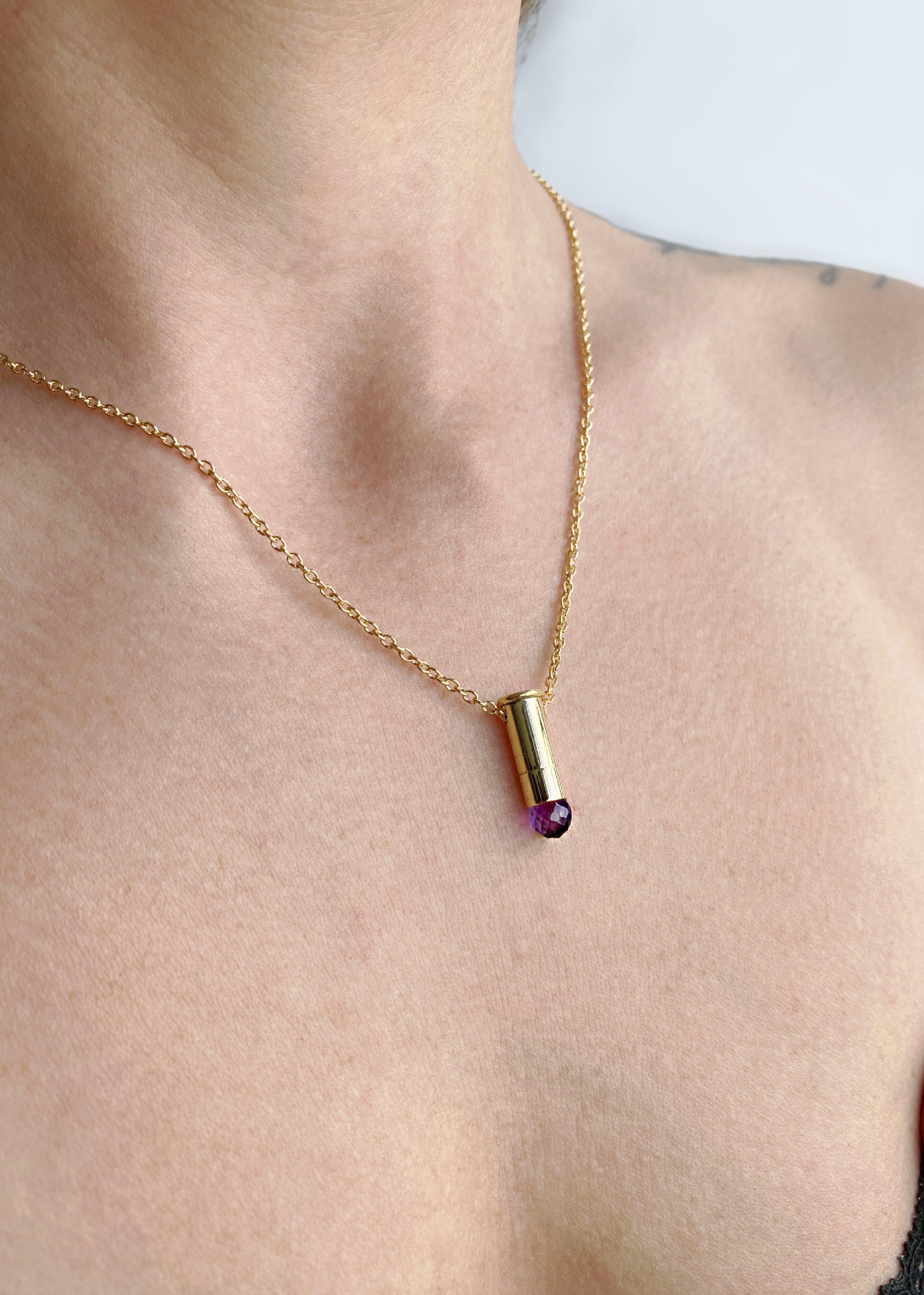This captivating necklace features a 22 caliber gold filled bullet casket set with a natural Amethyst briolette. This piece is from the “Peace” collection by Sebastian Jaramillo, commemorating the signing of peace between the Colombian guerrillas