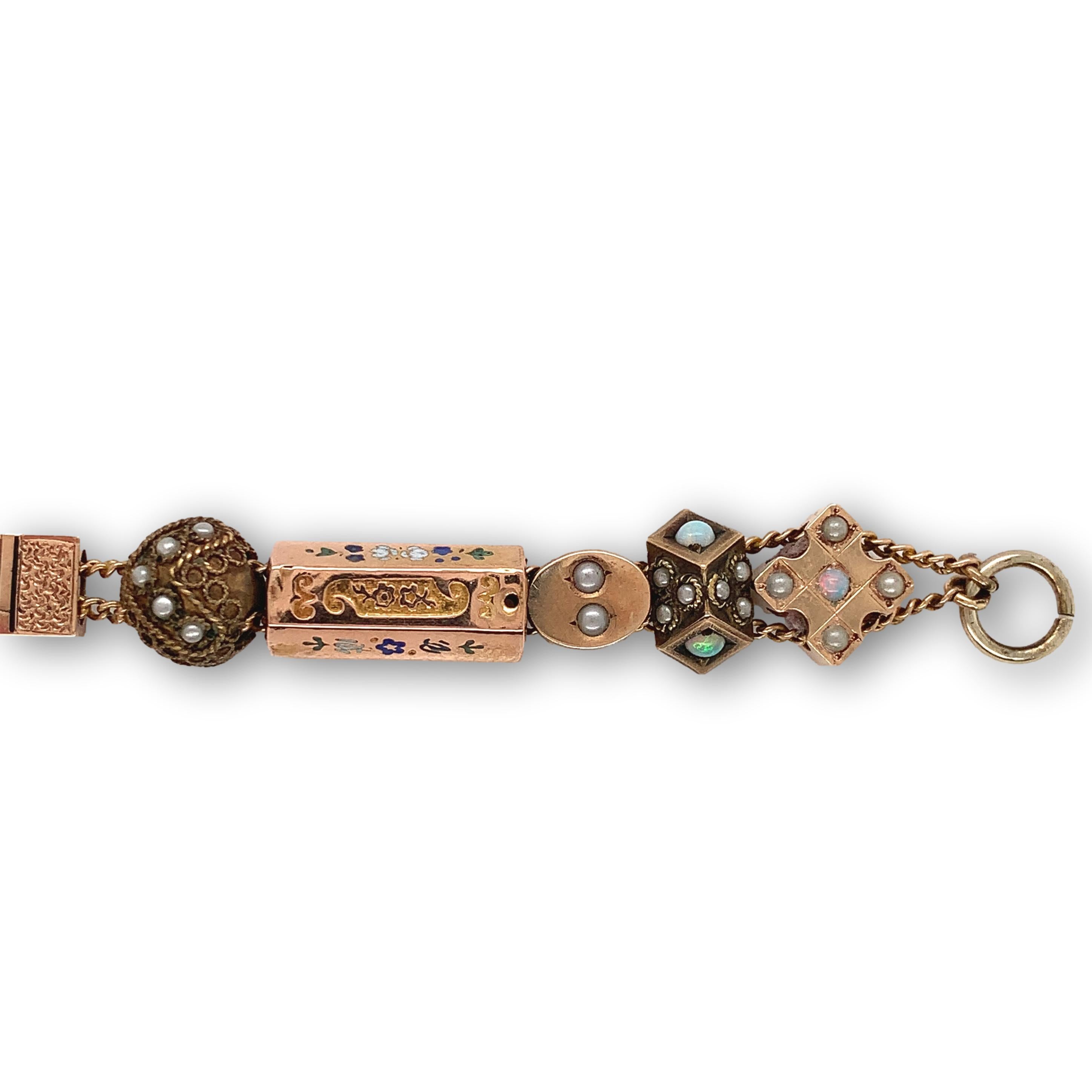 Gold filled bracelet with gold filled and gold top variety of 15 Victorian watch chain slides. Accenting the slides are small round opals, a black & white agate stone cameo, enamel accents, turquoise, and seed pearls. I suspect the turquoise are