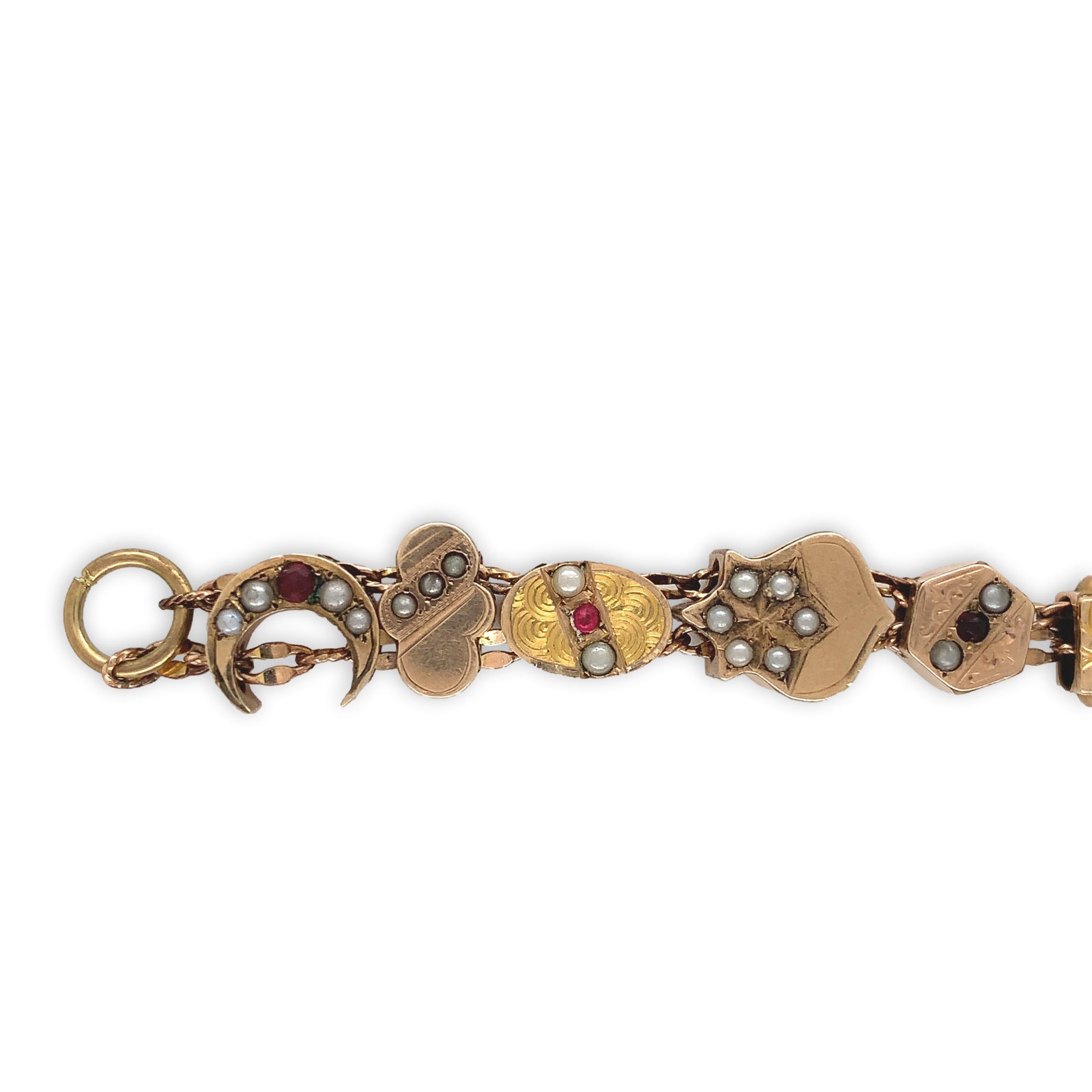 Gold filled bracelet with gold filled and gold top variety of 16 Victorian watch chain slides. Accenting the slides are small rubies, garnets, and seed pearls. I expect the colored stones are glass. The bracelet measures 7 1/2