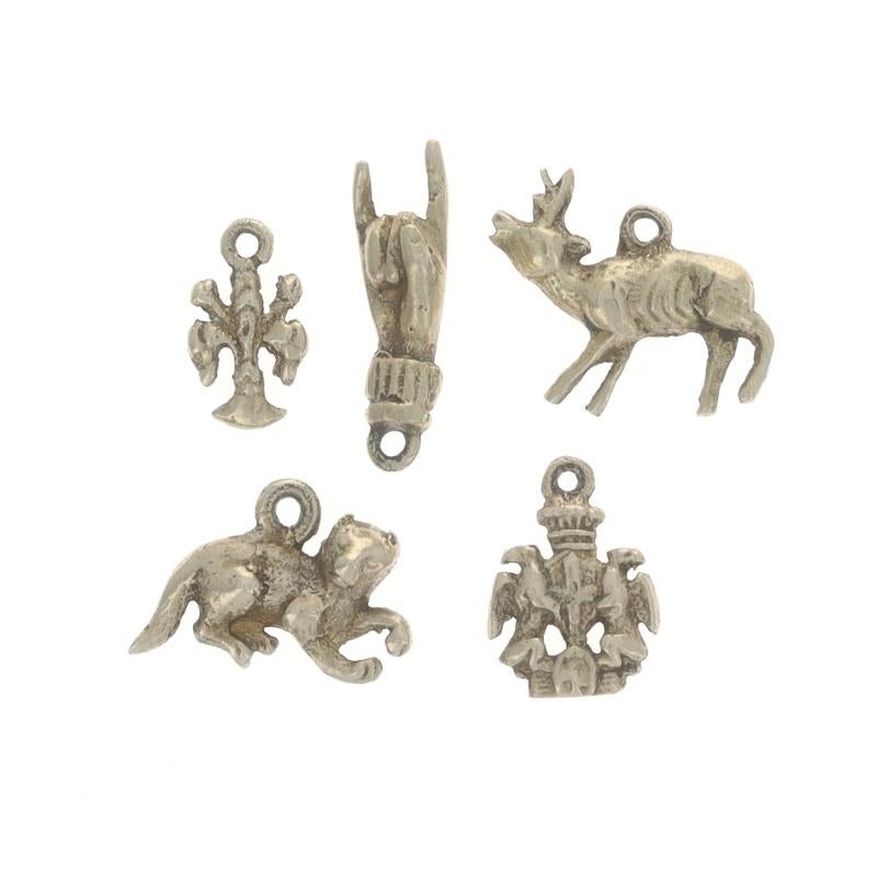 Era: Vintage

Metal Content: Gold Filled

Style: Set of 5 Charms
Theme: Fleur-de-lis, Sign Language, Deer, Cat, & Coat of Arms

Measurements

Item 1: Longest Charm (signing hand)
Tall (from stationary bail): 27/32