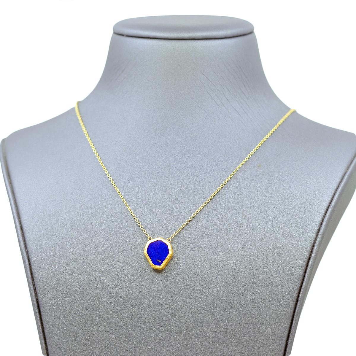Lapis Drop Necklace by renowned jewelry maker Devta Doolan featuring a deep blue lapis lazuli heptagon hand-fabricated in Devta's intricately-finished 22k yellow gold on a 22 inch hand-finished 18k yellow gold chain. Total Length with drop - 22.5