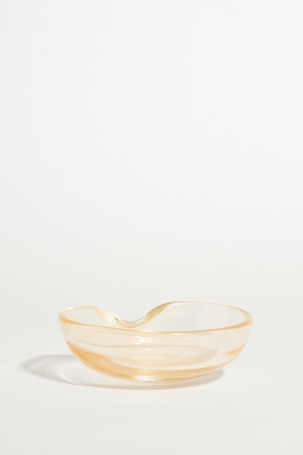 Simple gold flecked glass catchall with indented rim by renowned Italian designer Elsa Peretti for Tiffany and Co.