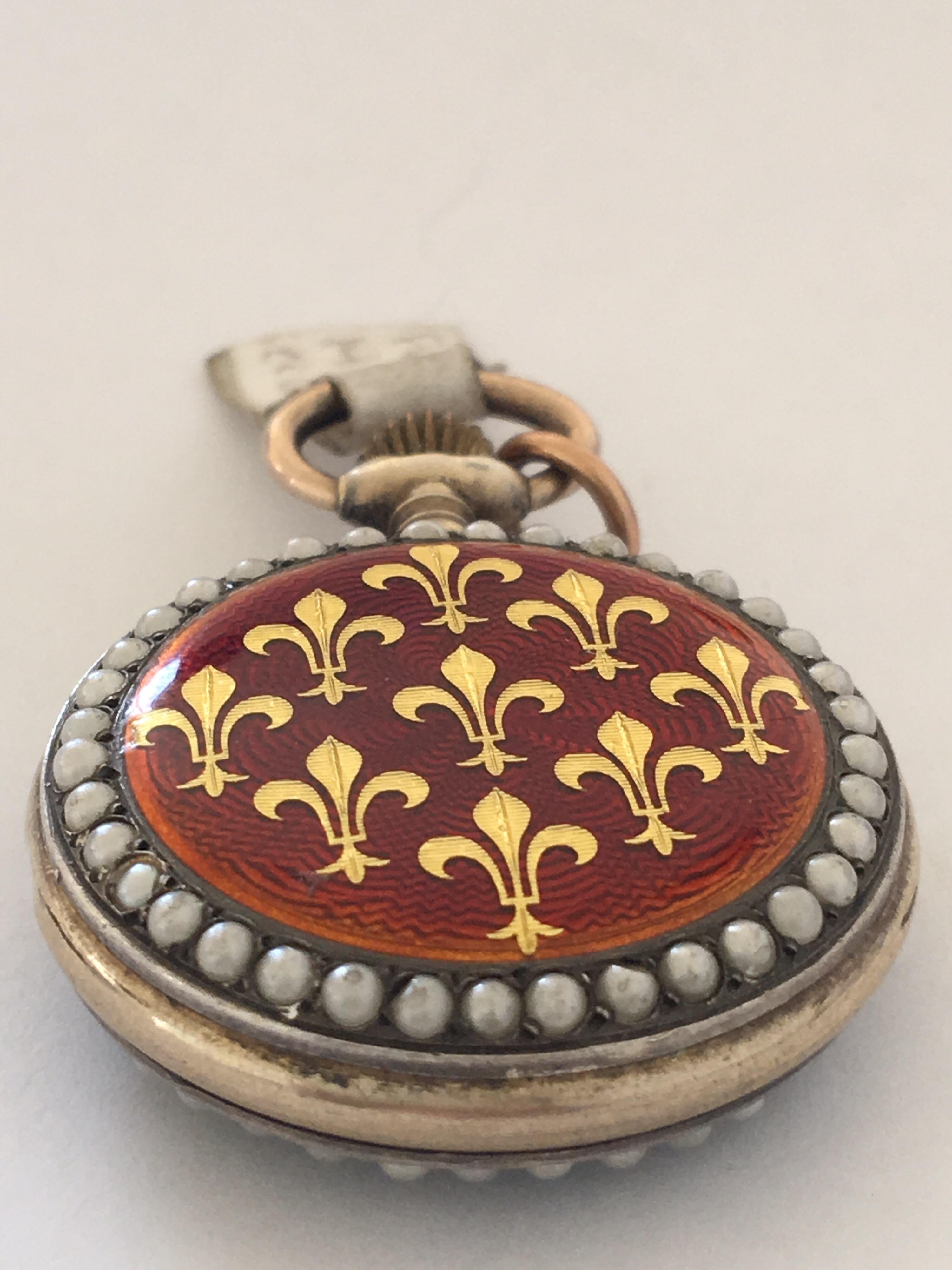 Gold Fleur-de-lis Inlaid In red Enamel, Seeded Pearl Silver And Gold Case Fob watch 

This beautiful Fob watch is in good working condition.

