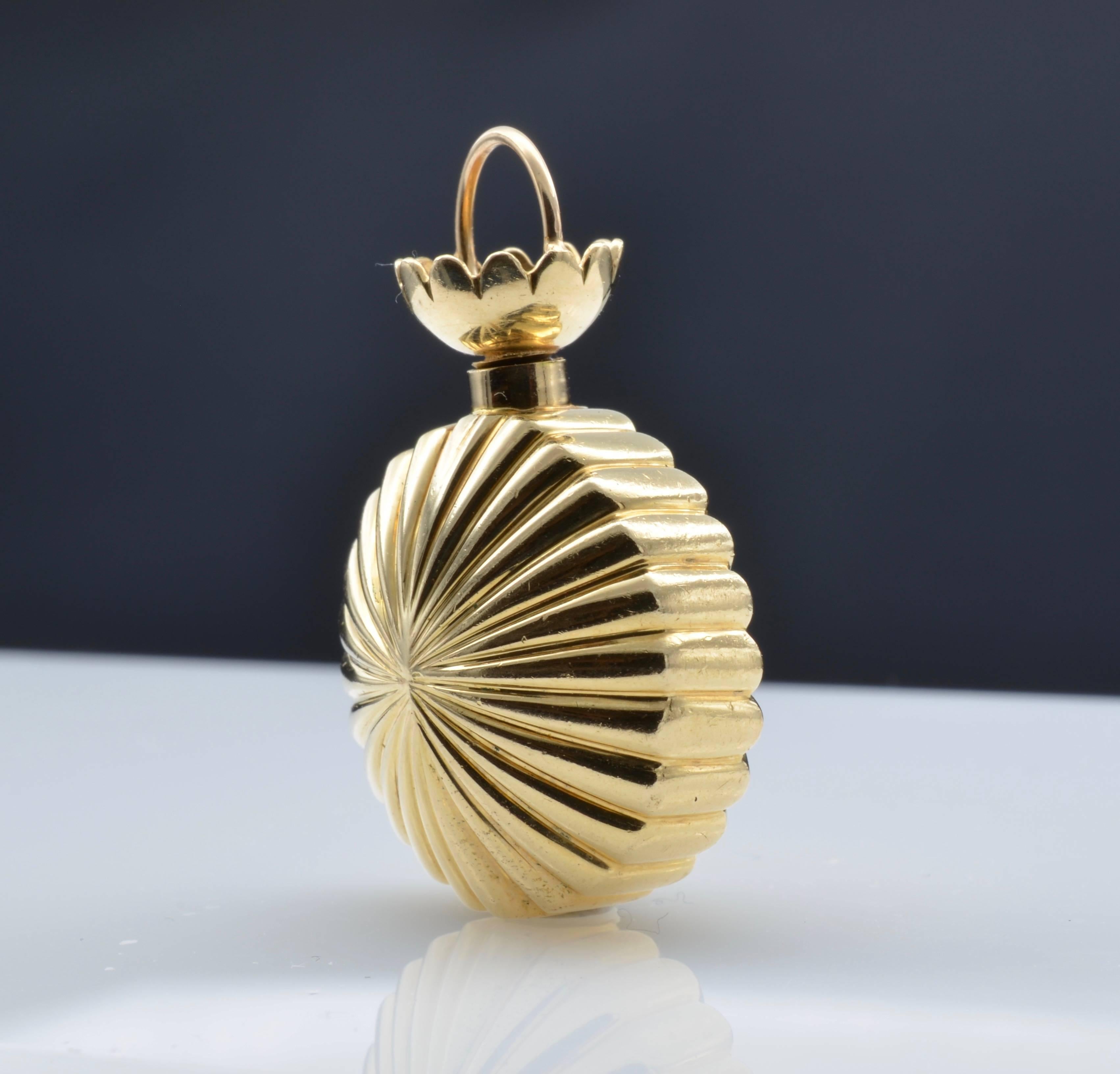 This adorable gold fluted pendant is a perfume bottle and can be used as such or just hang it from your favorite chain and layer it with other necklaces for a dramatic effect. The screw top is secure and the pendant has a nice weight to it. The