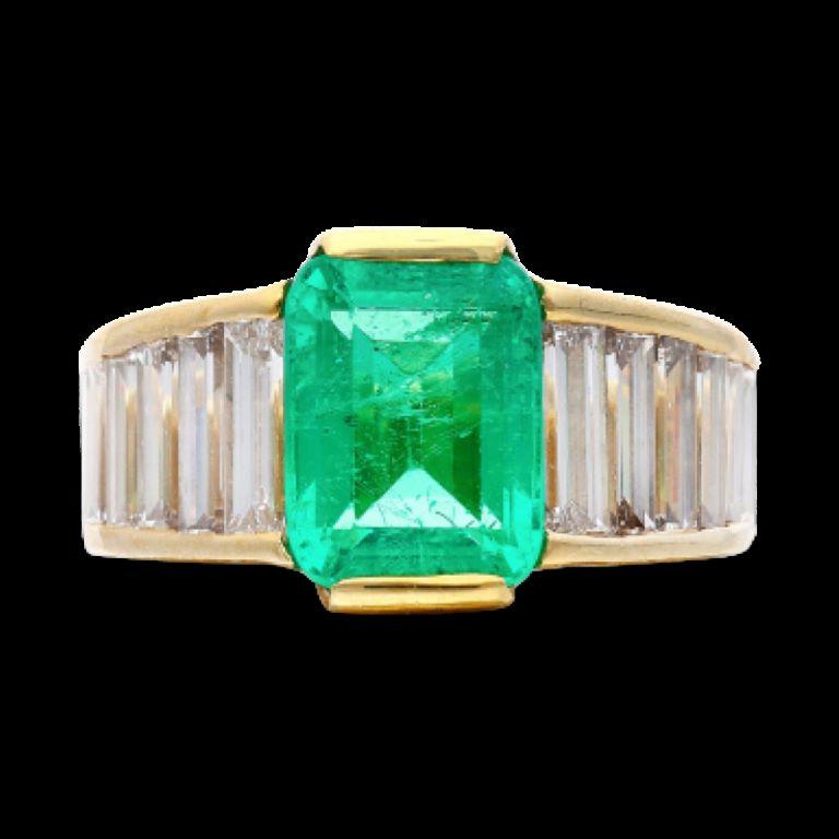 Centering a Colombian emerald cut emerald, accented by 12 baguette shaped diamonds.
Emerald weighs 3.20 carats
Diamonds weighing a total of approximately 3.00 carats
Size 7 1/2
18 karat yellow gold
Accompanied by SSEF report no. 104894, dated 14