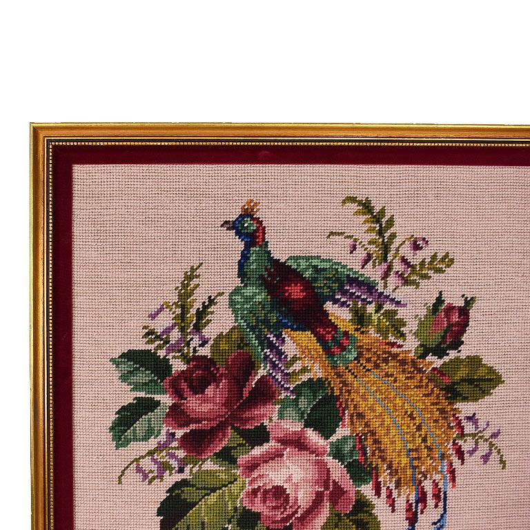 A lovely square framed hand embroidered wall hanging of a peacock and roses. This beautiful piece has been cross stitched by hand in a variety of bright and bold colors. A peacock takes center stage on this piece. Its wings are a mixture of blue and