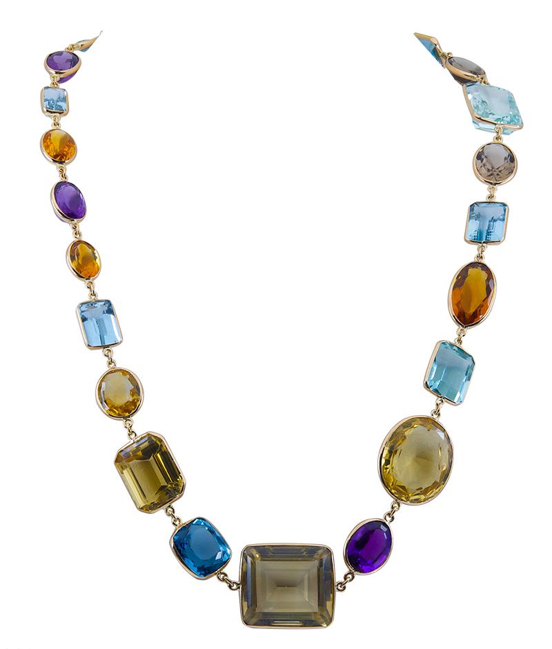 Sparkling necklace, with large multi-shaped gem stones:  citrine, amethyst, topaz, smoky quartz and a bright little aquamarine.  18K yellow gold.  Substantive, chunky and cheerful.  Candy for the decolletage.  30