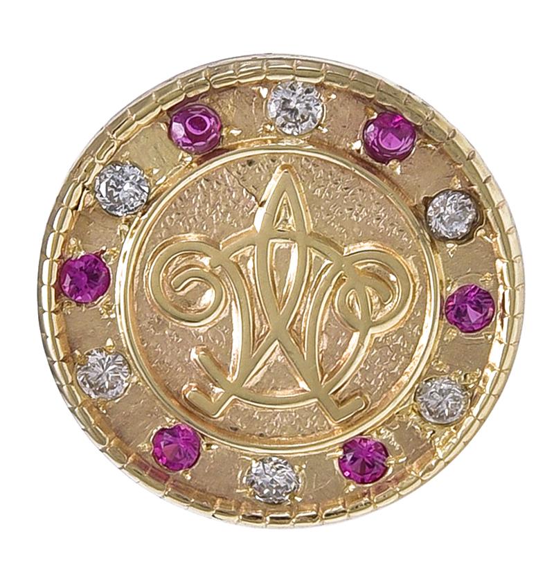 Round tie-tac, with the insignia of the Metropolitan Club of New York City.  Set with faceted rubies and diamonds around the border.  14K yellow gold.  1/2