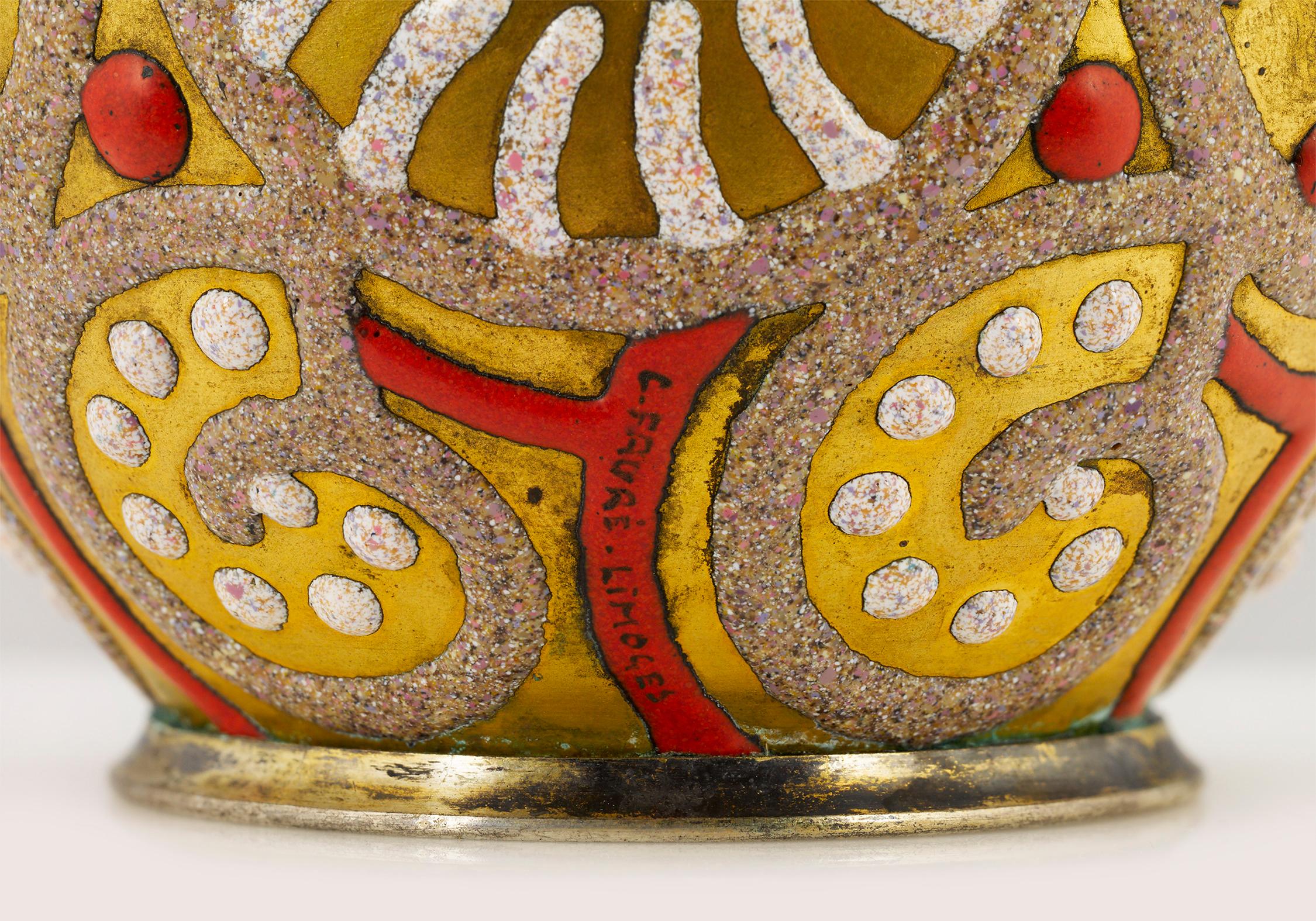 Playful dots, stripes and swirls cover the luminous gold form of this vase by the famed French enameller Camille Fauré. Fauré revolutionized enamel designs of the Art Deco era with his signature technique of hand-applying layers of colorful enamels