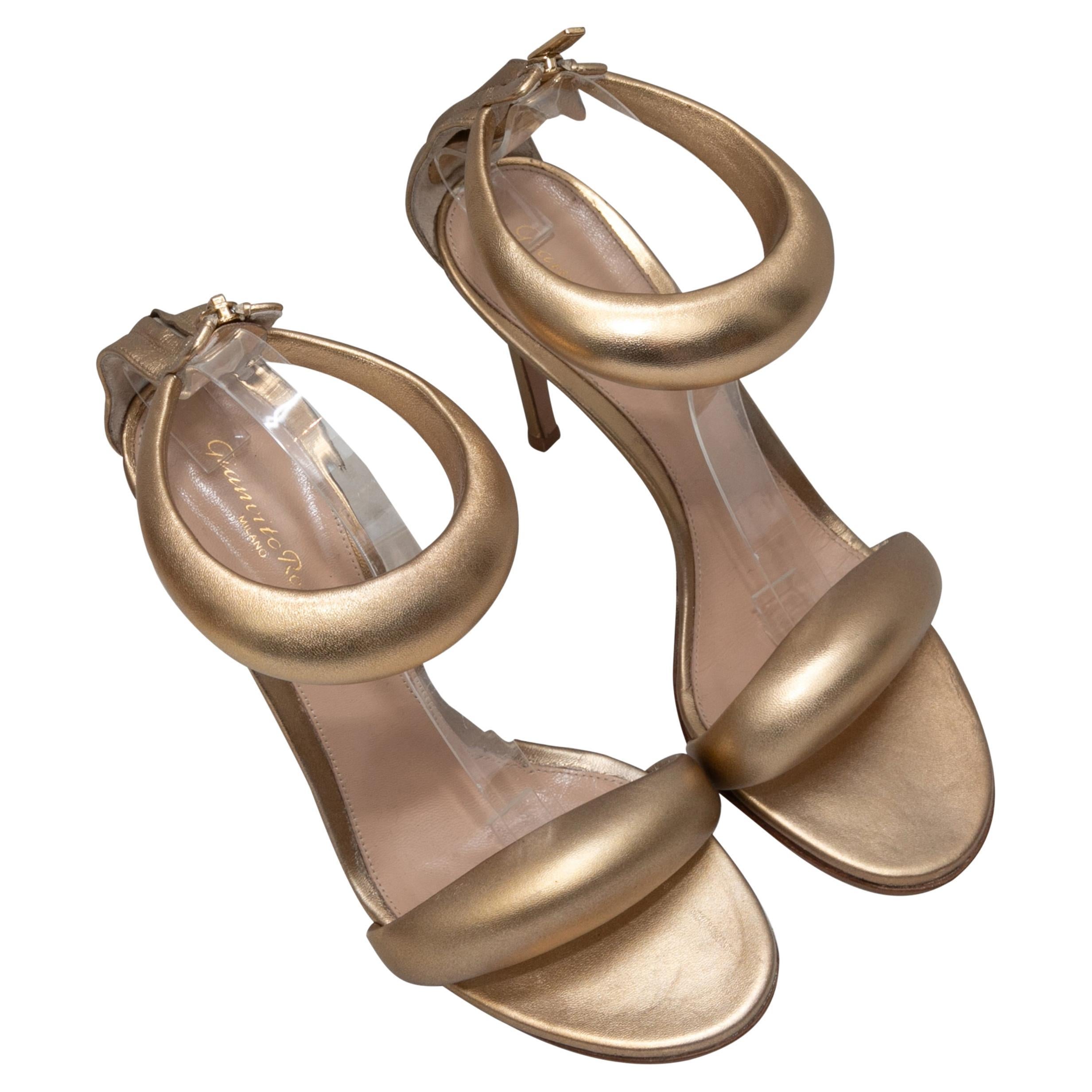  Gold metallic leather Bijoux heeled sandals by Gianvito Rossi. Zip closures at counters. 4.25