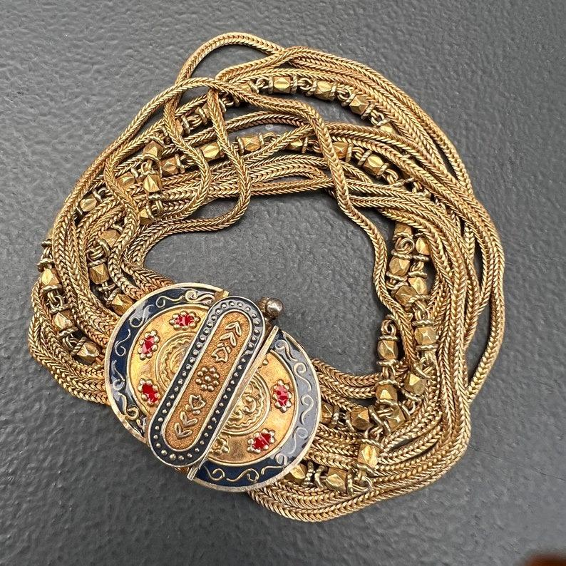 This beautiful, handmade Turkish bracelet features a stunning Byzantine-style design, crafted with gold gilded sterling silver. The bracelet consists of 10 intricately handmade chains, each showcasing fine craftsmanship. The clasp is enhanced with