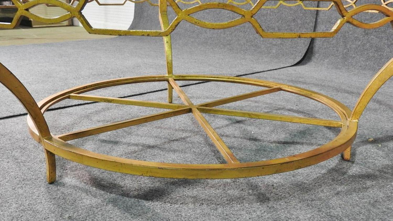 This is a simple and sophisticated coffee table. The thick glass top adds lightness to a room and the gold base with genuine gold leaf gilding adds glamour. The table measures 16