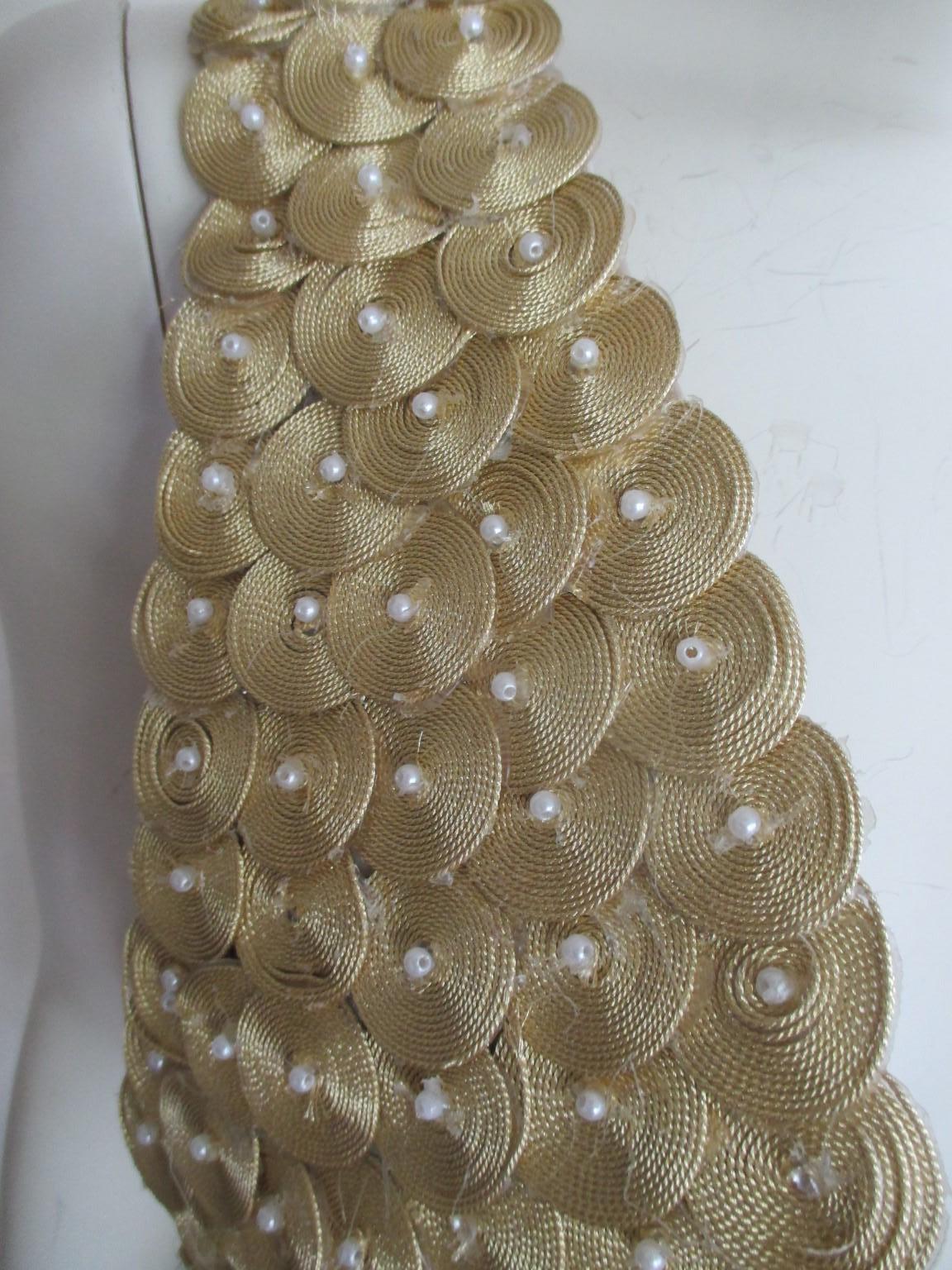 Traditional oriental handmade vintage bustier/gilet

We offer more exclusive vintage items, view our frontstore

Details:
Gold fabric decorated with faux pearls
no buttons, no label
Fully lined
Pre owned condition with some wear of use, see