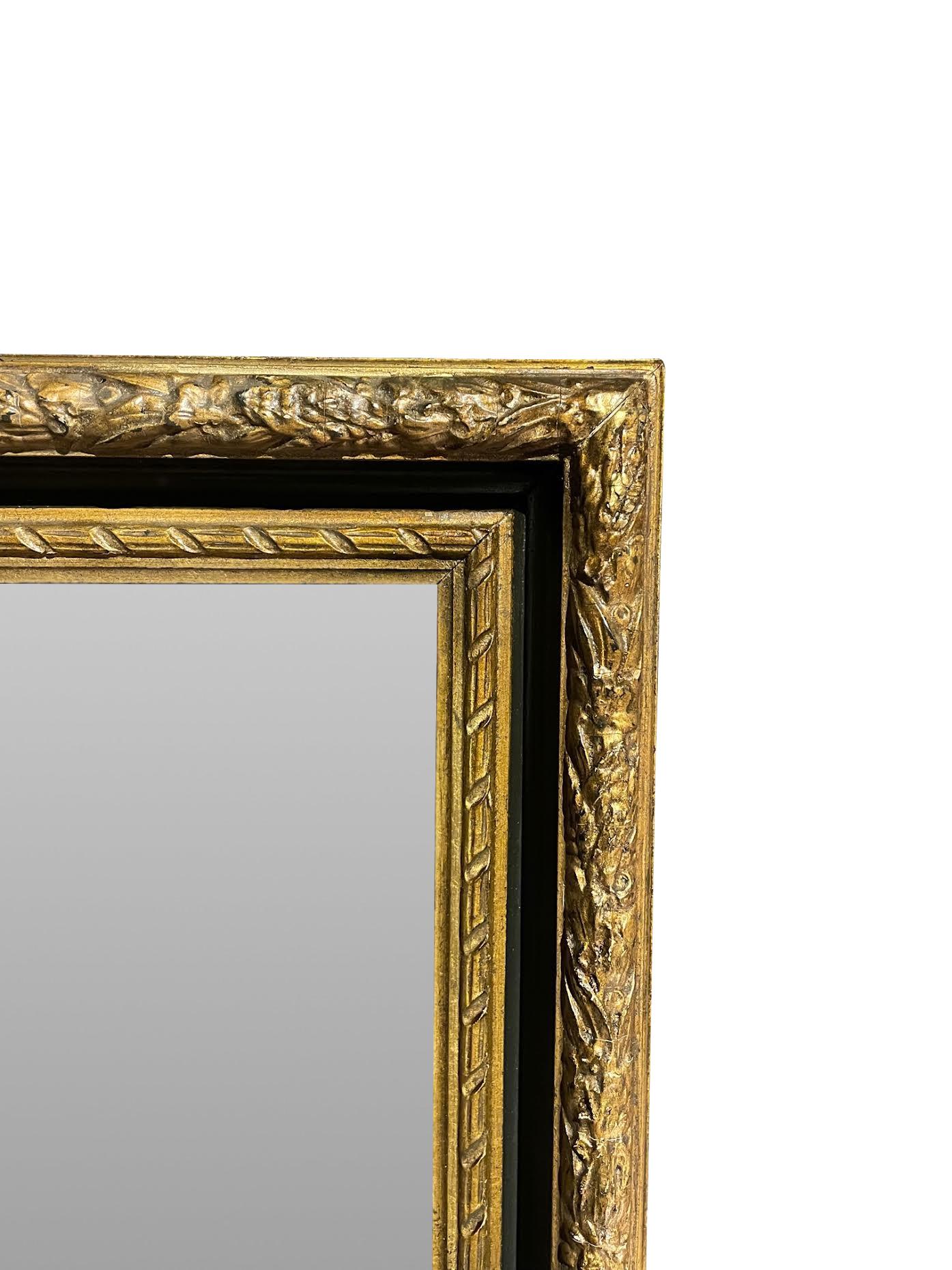 19th century French gold gilt and ebony frame mirror.
Scroll design.
New beveled mirror.