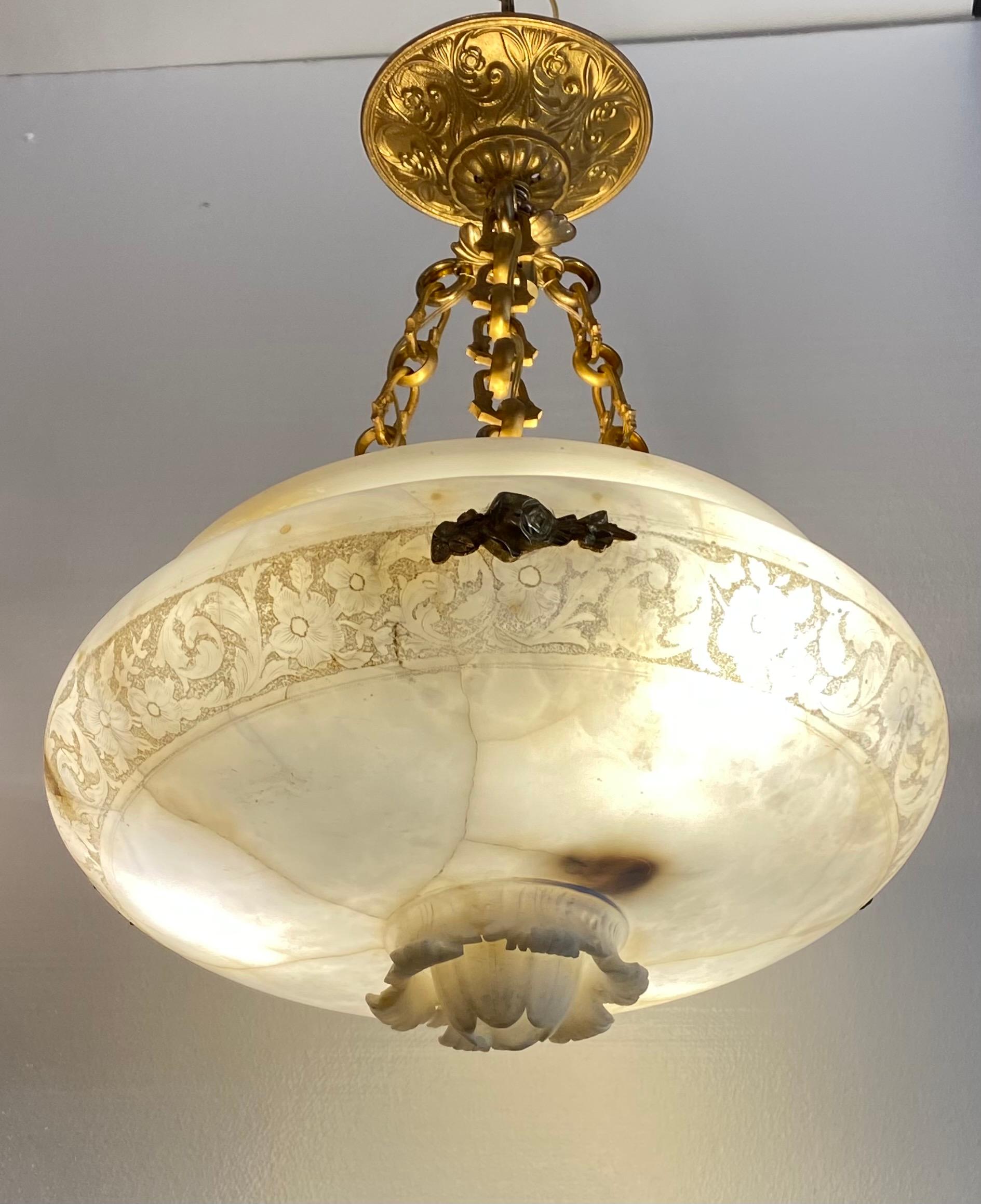 Fine vintage gilt bronze chandelier. Featured gold tone chains from which is held a circular alabaster shade with floral motifs. Good estate fresh condition.