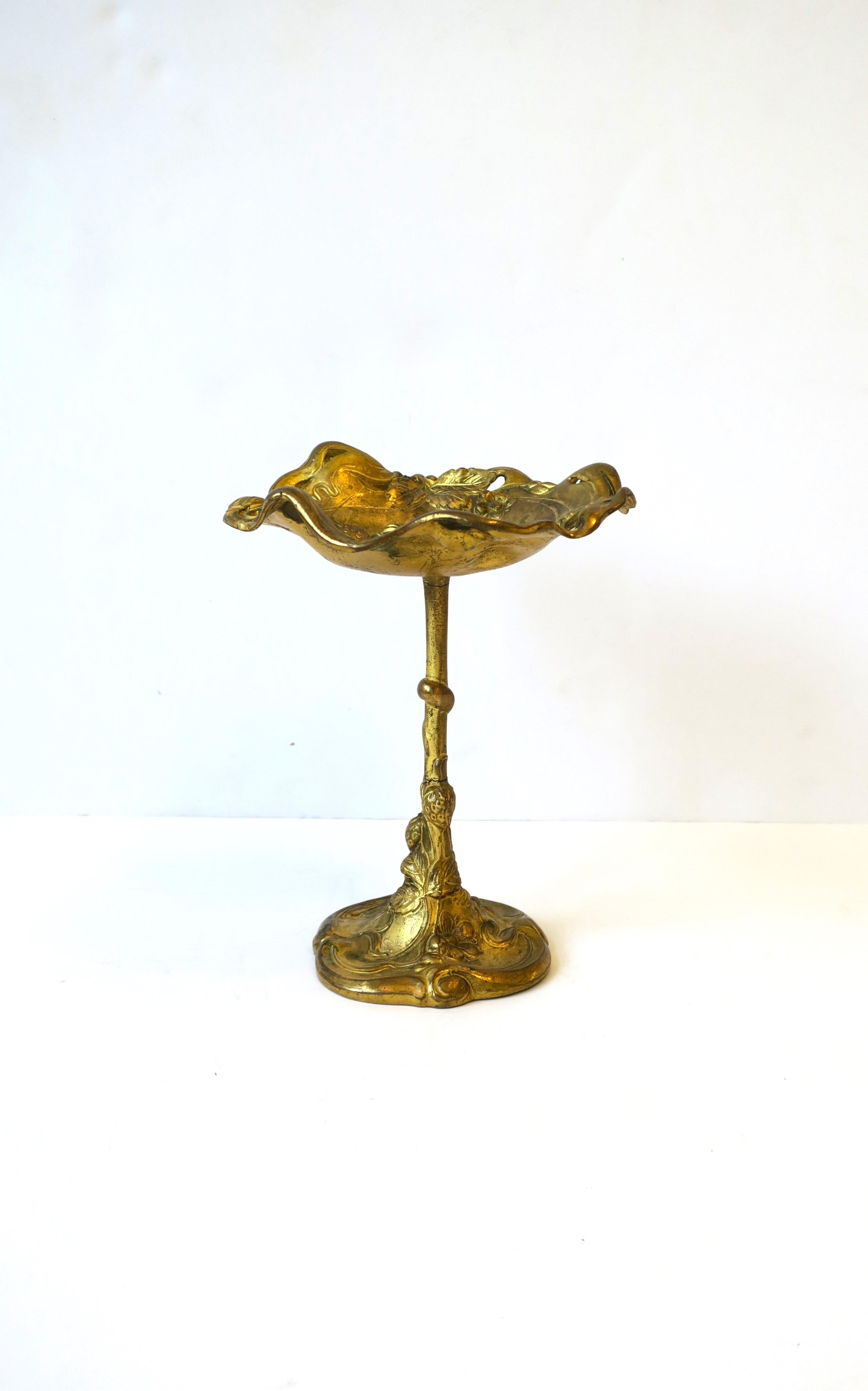 A gold gilt bronze compote or tazza in the Art Nouveau style, circa early 20th century. Piece is decorated with a raised relief of strawberry fruit, vines, leaves and flowers. Dimensions: 7.5