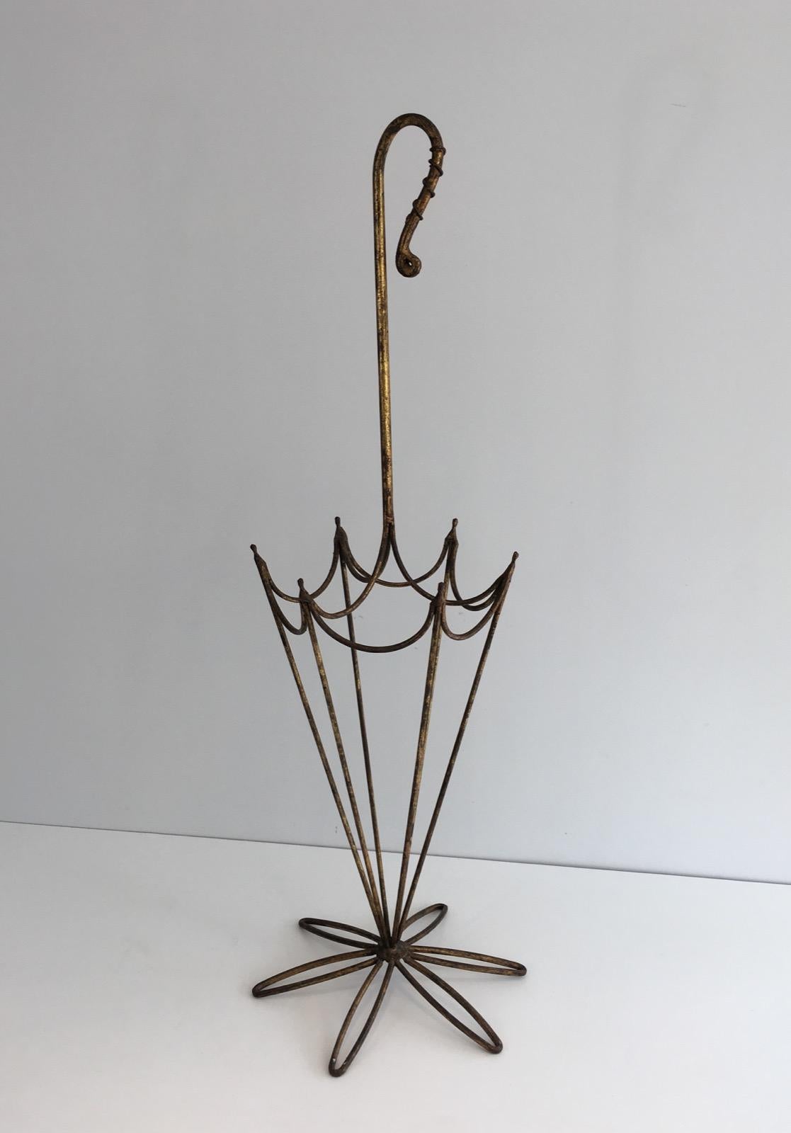This unusual umbrella stand is made of gold gilt iron. This represents an umbrella made of gild gilt iron. This is a Spanish work form 1940.