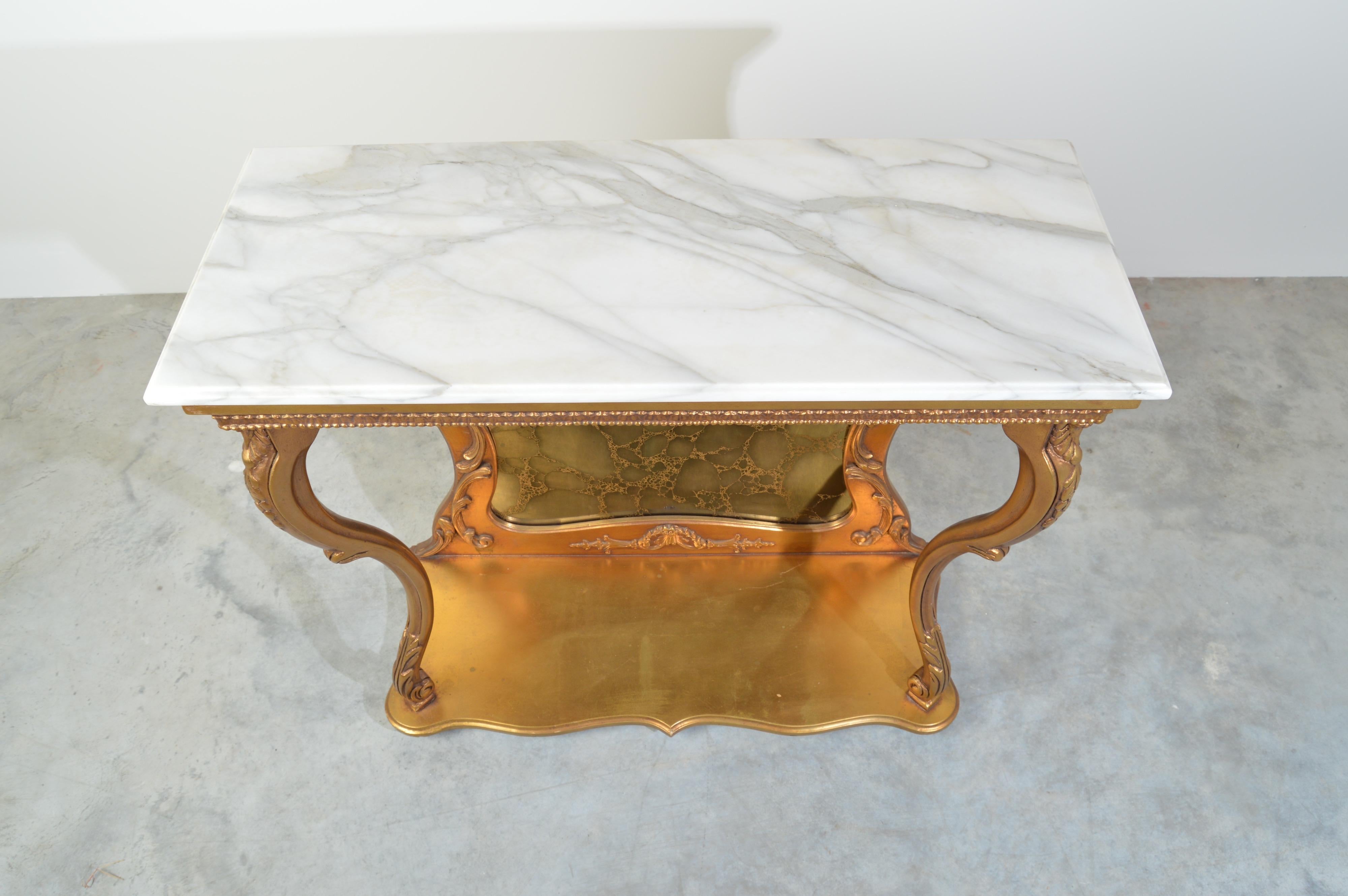 Gold gilt Louis XV style French marble top console table with antiqued mirror circa 1950.
Very nice condition having minor signs of age and use.
Clean and solid!