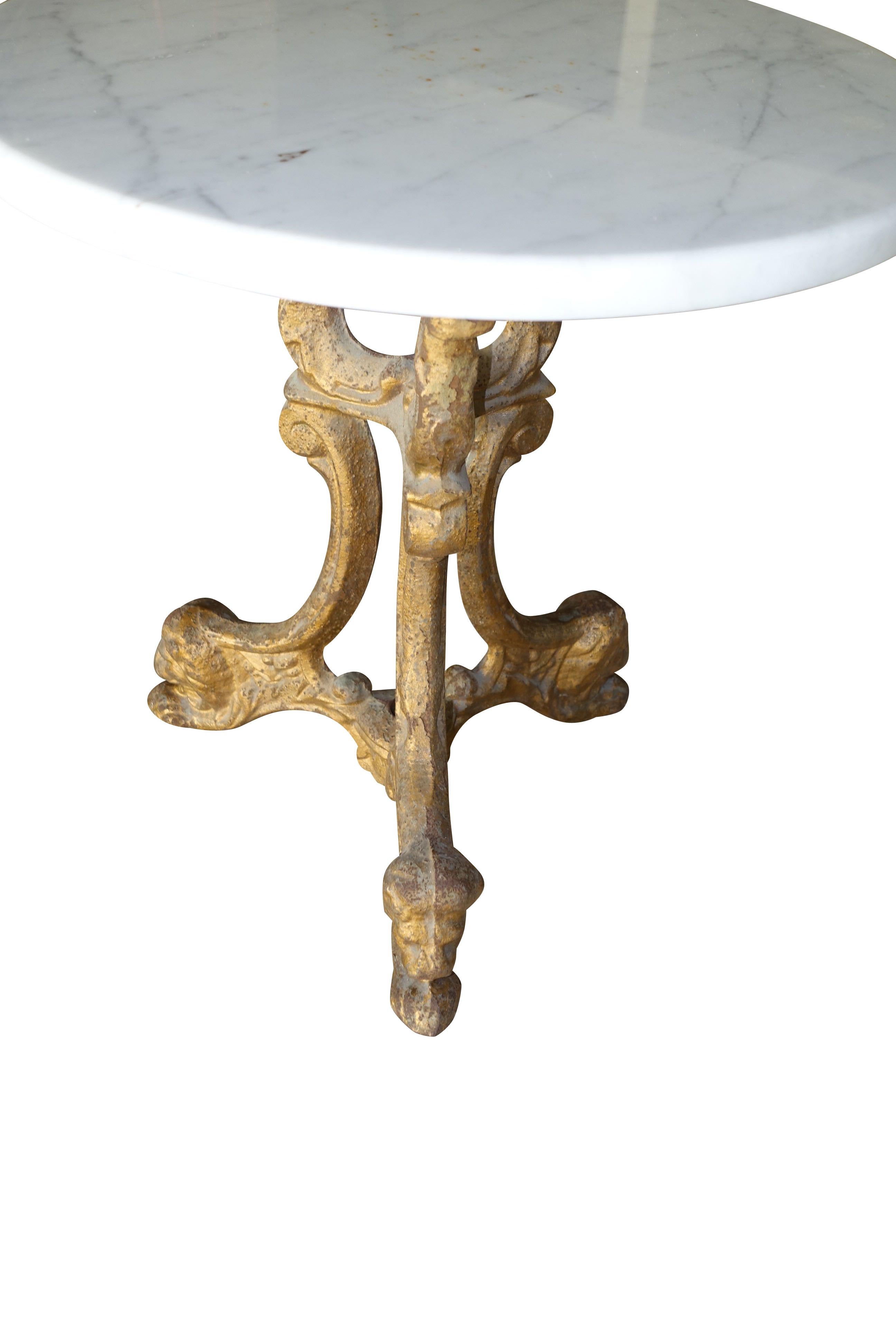 This 1920s French gold gilt metal cocktail table has was originally housed on a cruise liner.
A white marble top sits atop the gold gilt metal base.
A decorative griffin foot motif adorns the three legs.
The table is very sturdy.