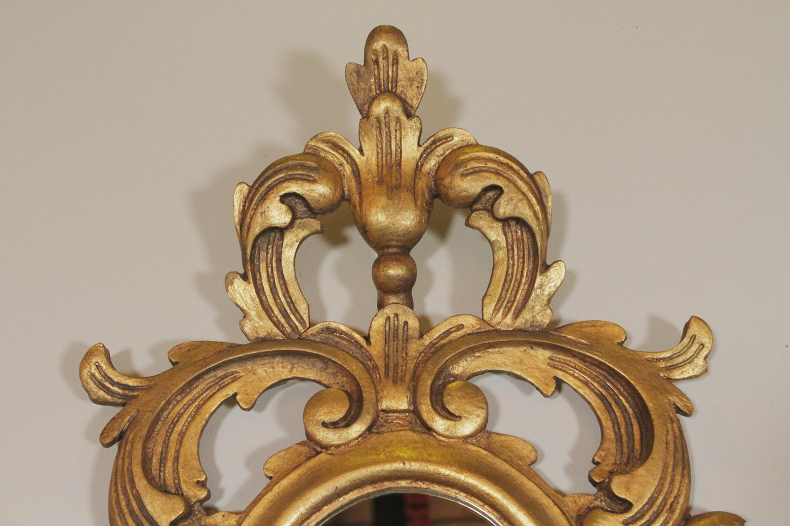 Gold gilt Rococo style carved wood mirror made in Spain
Dimensions: 31”W x 53” H 4” D.
 