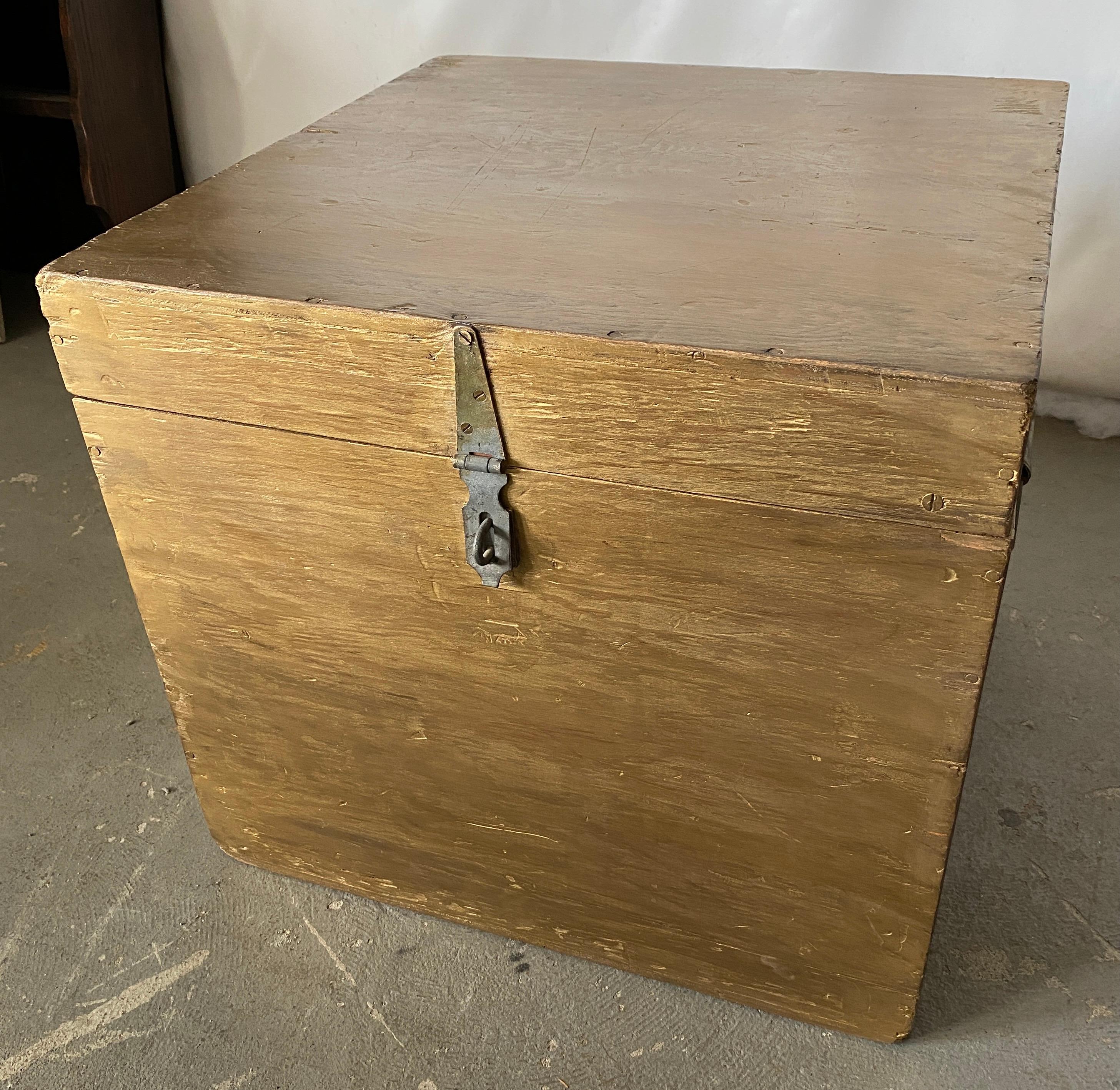 The size of this small antique American square chest lends itself to be used as a side table, end table or coffee table. The sides have handles allowing the piece to be moved easily. The box with clean lines has new gold gilt finish making it a