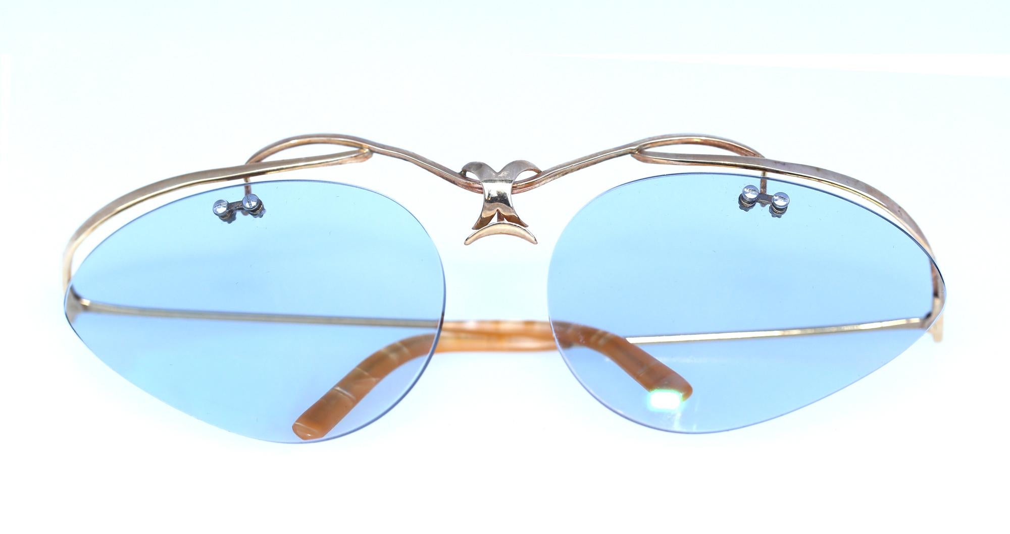 Gold Glasses Stylish Yellow frame with tinted glass. The shape is reminiscent of the Art Nouveau styling with natural ornamentation and really airy shapes. The tinted glass is not really dark, so it is just perfect for wearing indoors.
It is a