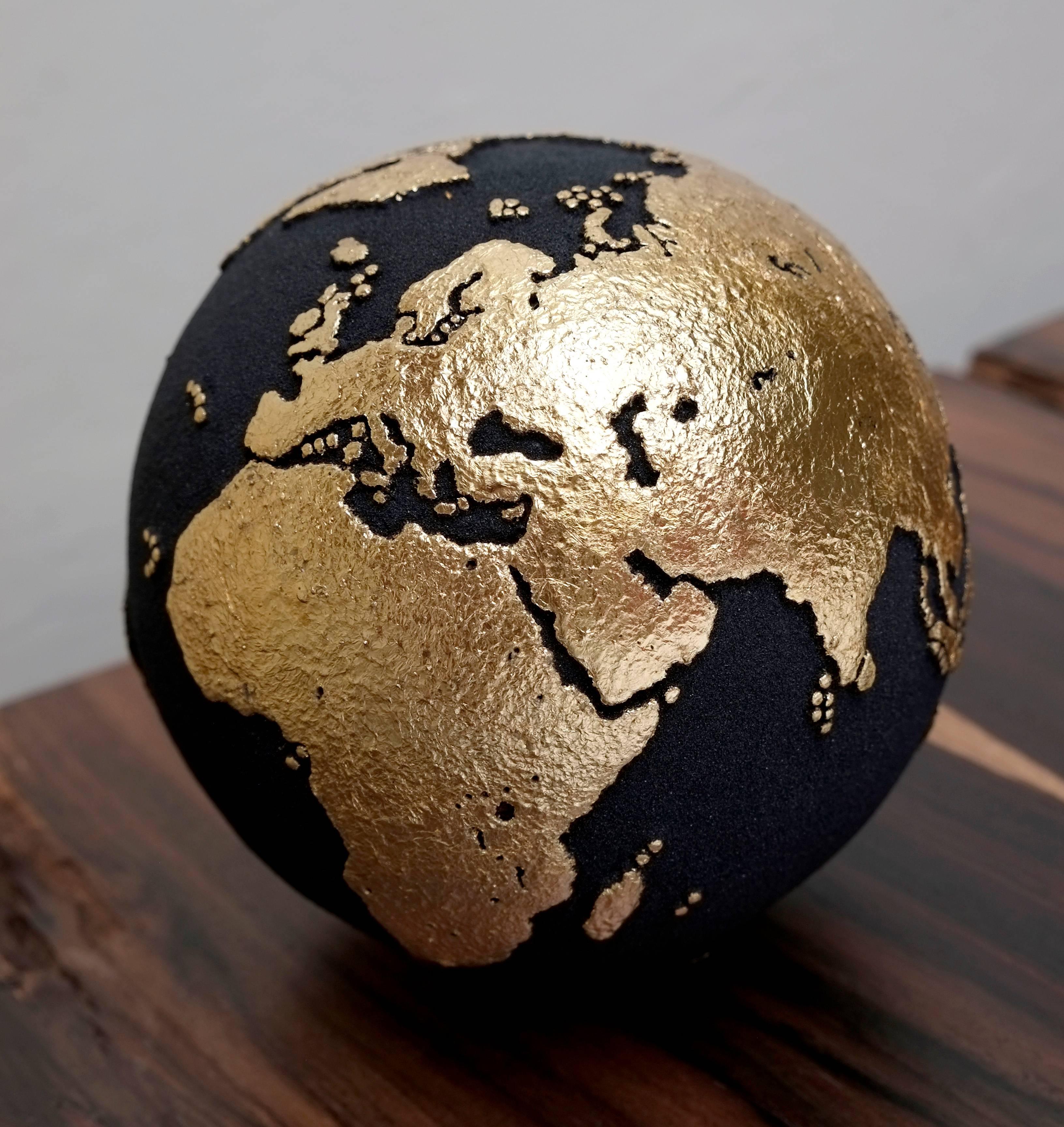 Say it with gold.

Adorable little handcrafted wooden globe made of teak root and volcanic sand, with 23-carat gold leaf finishing. A certainly ideal piece as gifts for friends, loved ones, or for yourself.

Dimension: 7.87 in / 20 cm
Materials: