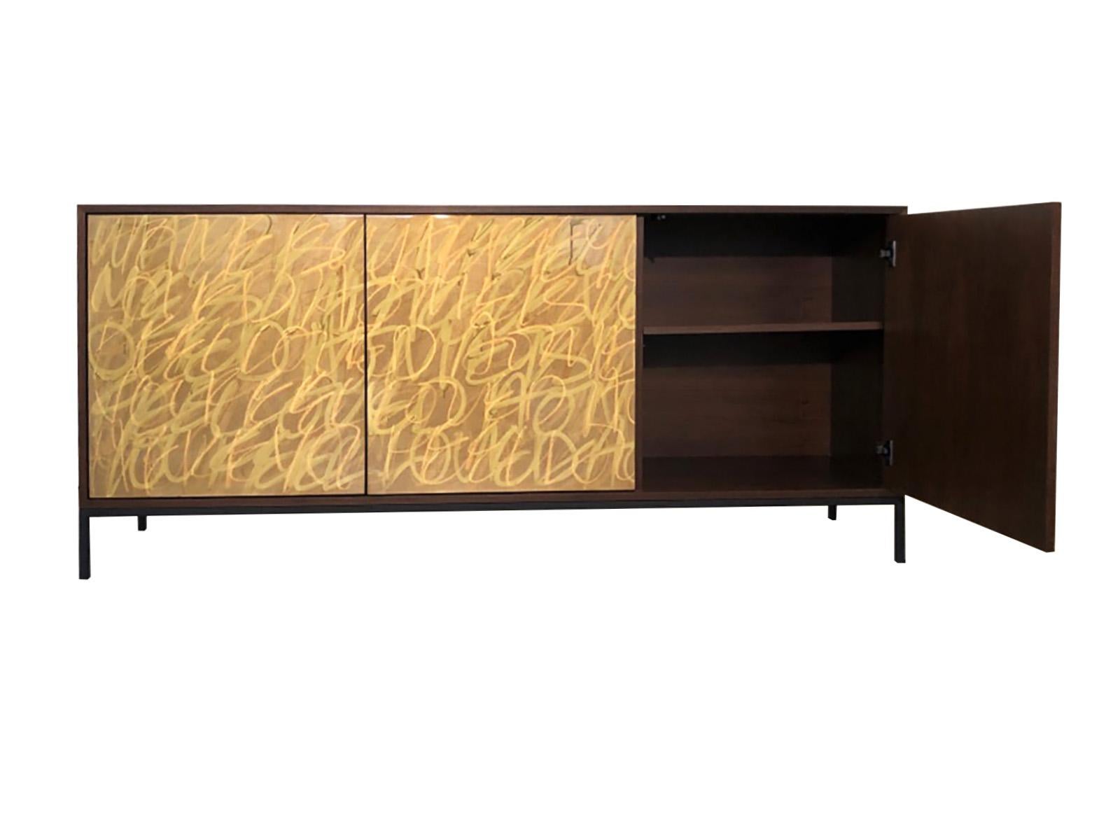 The Gold Graffiti Cabinet is designed and finished by hand in our Toronto studio.

The Gold Graffiti Cabinet is constructed of solid core walnut, body and doors.  The cabinet sits on a steel base finished in a matte black powder coat.

The walnut